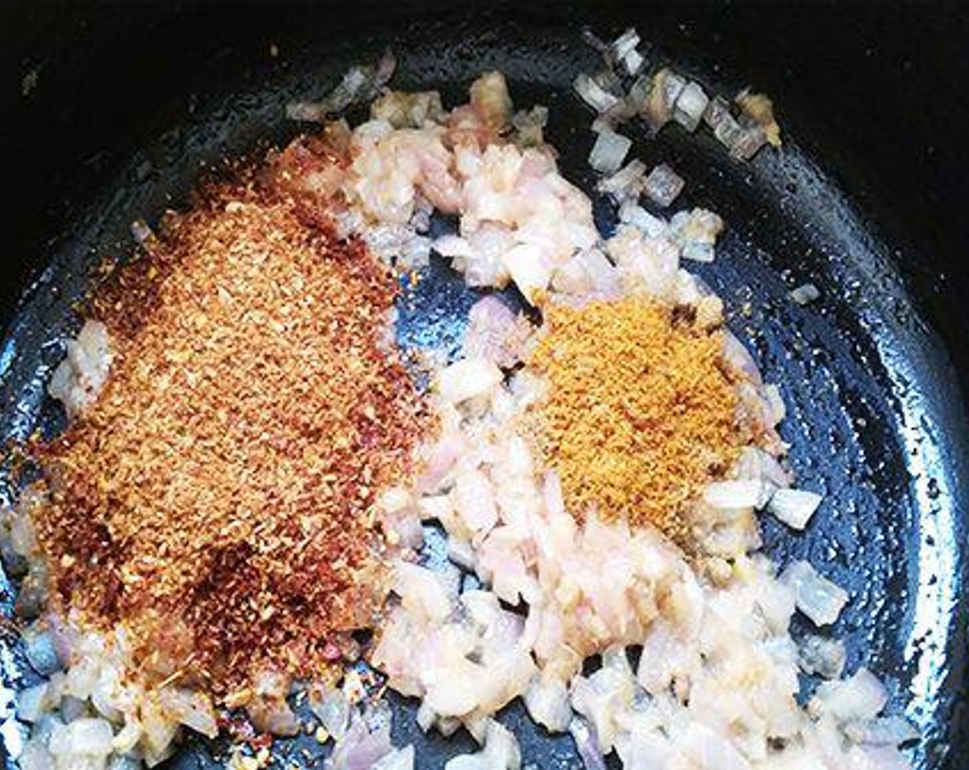 step 2 To a kadai pour Oil (1 Tbsp) and add Ginger Garlic Paste (1 tsp). Saute for three to four minutes and add finely chopped onion. Saute until it starts to change color. Now add the masala powder we made and Garam Masala (1/2 tsp). Saute until the raw smell of the masala is gone.