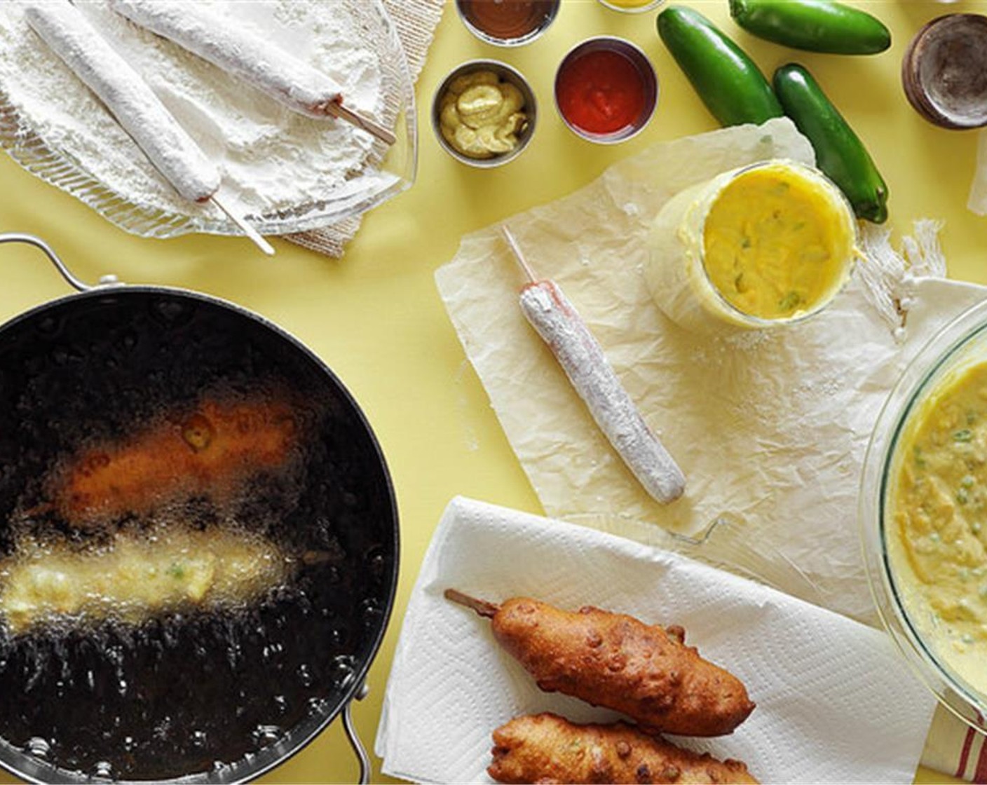 step 5 Carefully lay the coated corn dog into the hot oil. Cook two at a time so you don't overcrowd the pot. Fry until golden brown all around, about 4 to 6 minutes, turning halfway. Use a slotted spoon or pair of thongs to remove.