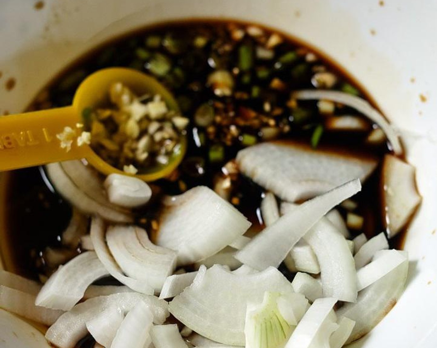 step 1 Mix Soy Sauce (3 Tbsp), Onion (1/2), Granulated Sugar (2 Tbsp), Garlic (1 clove), Scallion (1 Tbsp), Rice Wine (2 Tbsp), Sesame Oil (1 Tbsp), Coca Cola (1/2 cup), and French Baby Carrots (5) in a bowl or tupperware to make the marinade.