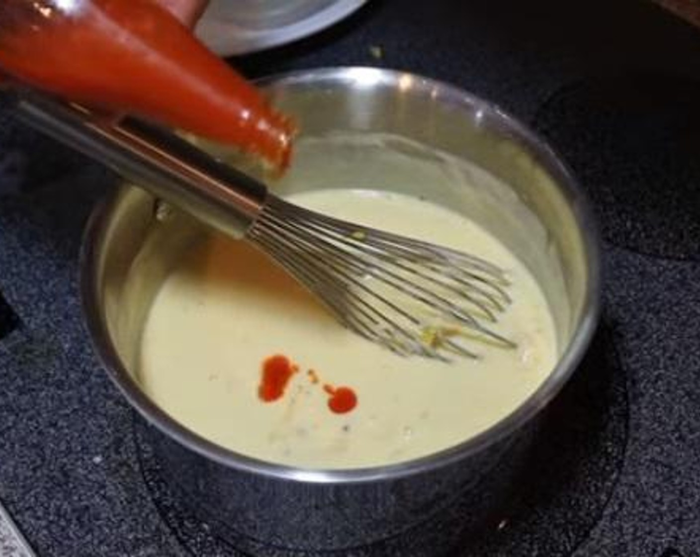 step 3 Start adding the Pepper Jack Cheese (2 cups) and Shredded Sharp Cheddar Cheese (2 cups) a little at a time, stirring to melt. Once the cheese sauce comes together, add the Hot Sauce (1 tsp) and season with a pinch of Salt (to taste) and Ground Black Pepper (to taste).