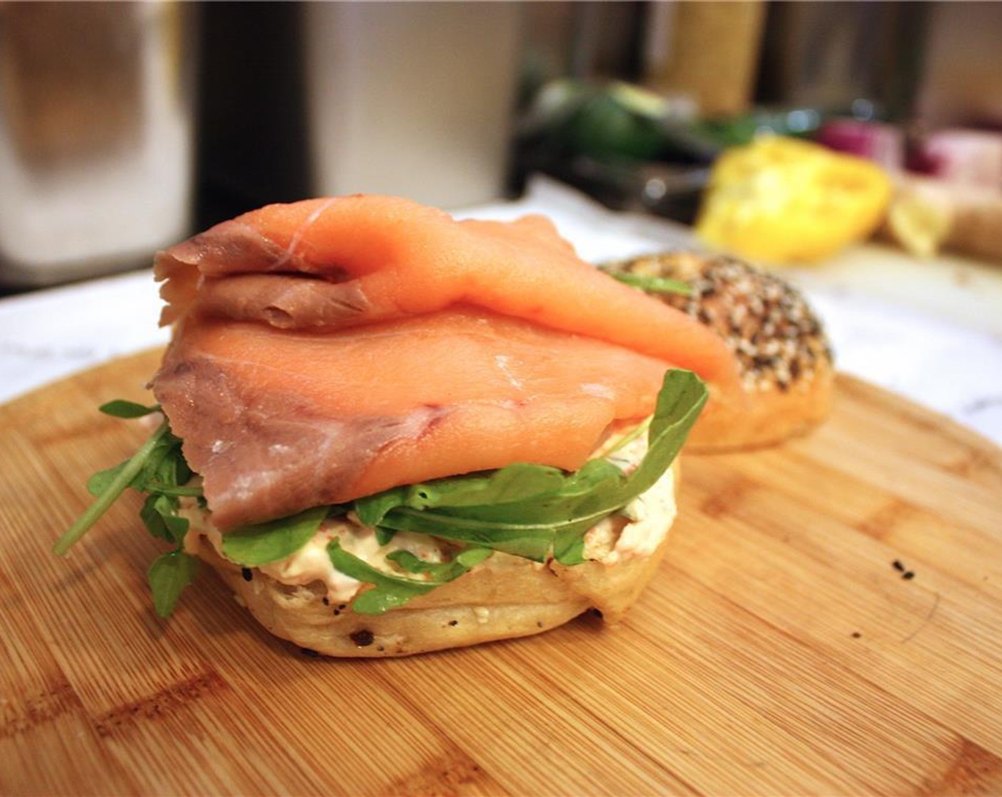 step 4 On bottom half of bagel, place Arugula (1/2 cup) on top of the tobiko cream cheese, and then nicely place the Smoked Salmon (2 slices) over the arugula.
