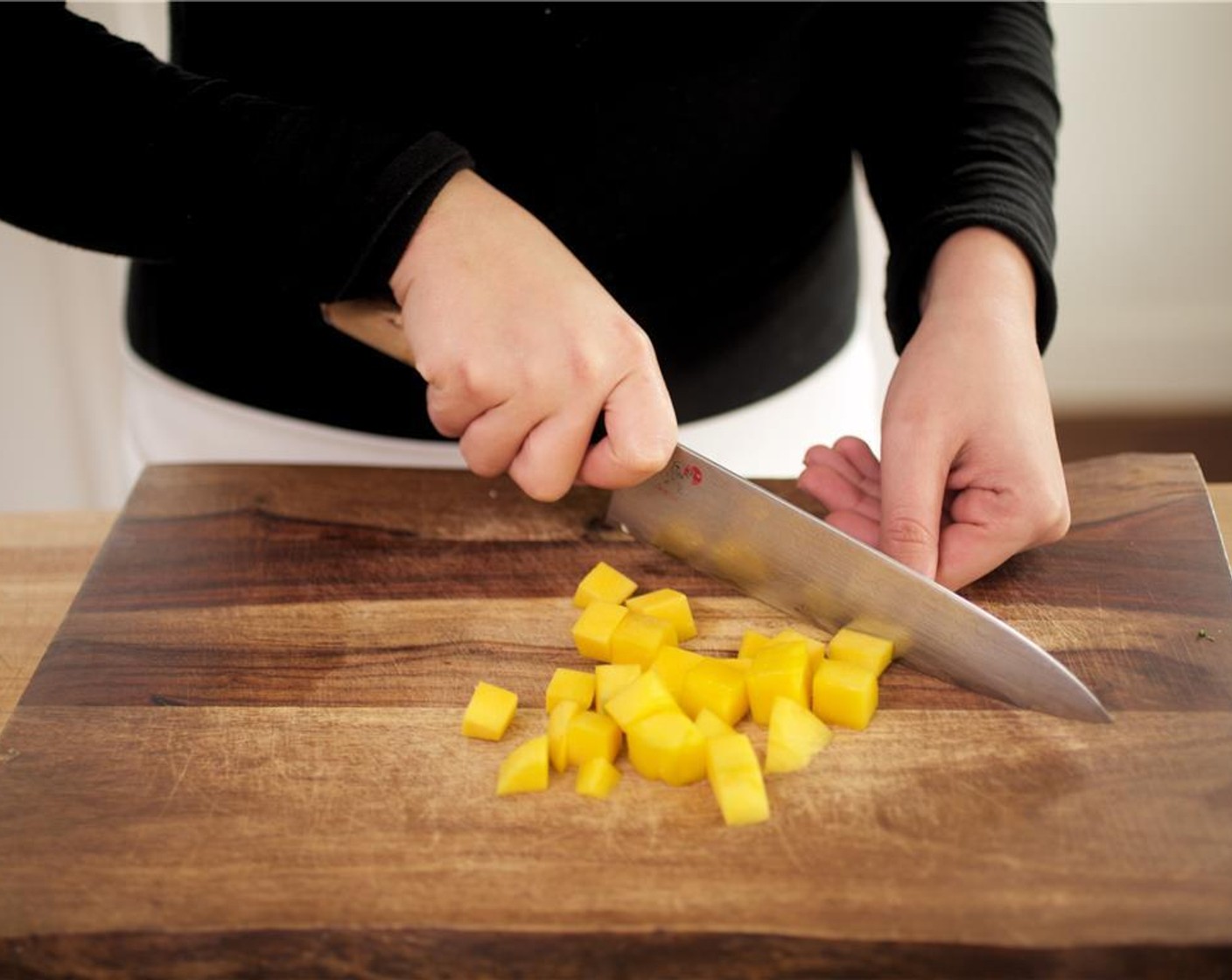 step 8 Peel the skin off the Mango (1) and remove mango flesh from pit. Discard the pit and dice mango into small pieces.