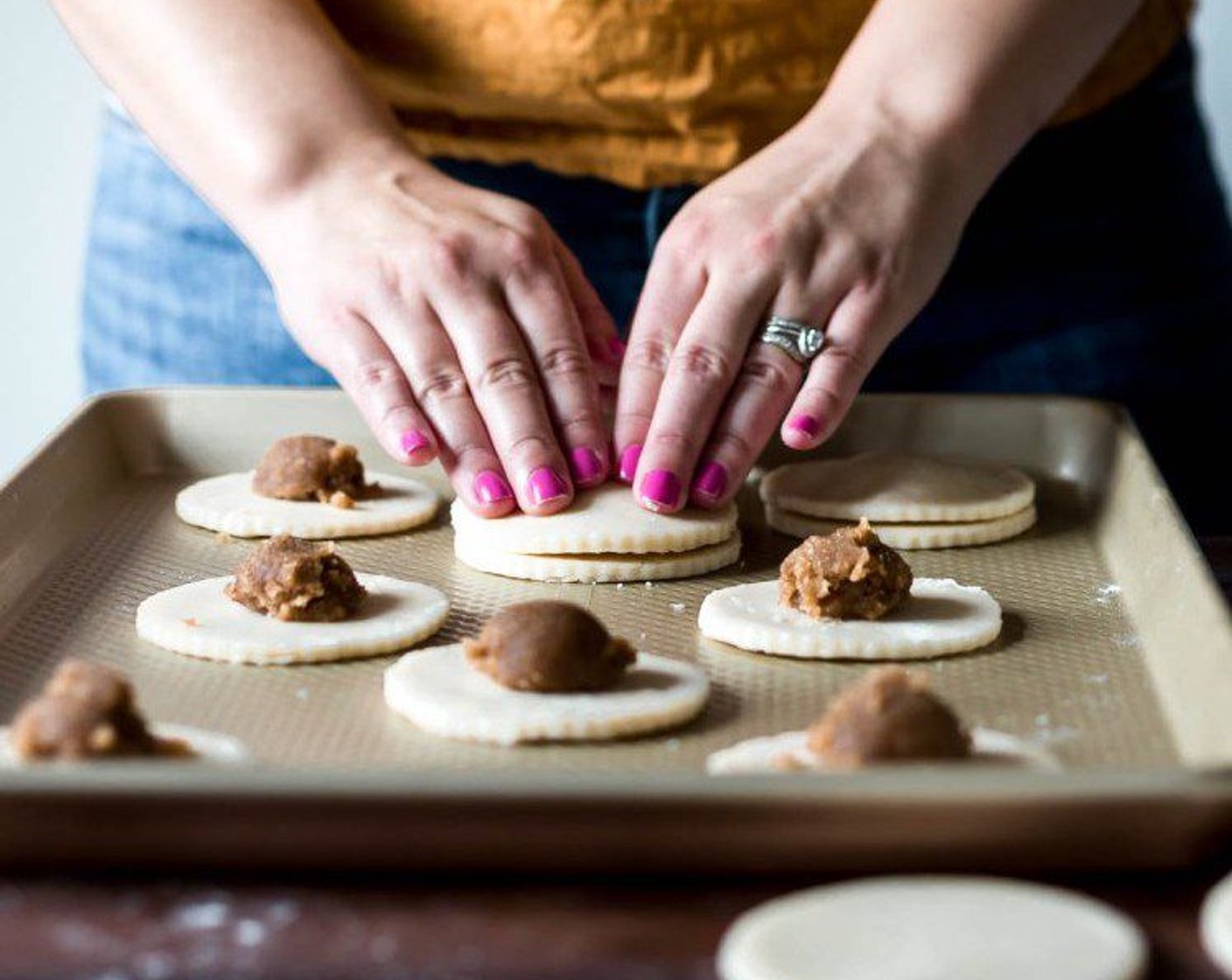 step 11 Dip your finger in water and sweep the circumference of each disk, then sandwich one dough disk on top of the other press around the circumference with a fork.