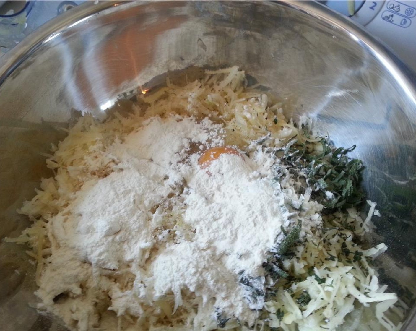 step 5 Add the grated stuff back to the bowl, along with the chopped herbs, All-Purpose Flour (1/4 cup), Egg (1), Salt (1 Tbsp), Granulated Sugar (1 pinch), and Ground Black Pepper (1 pinch). Mix everything together until homogenous.