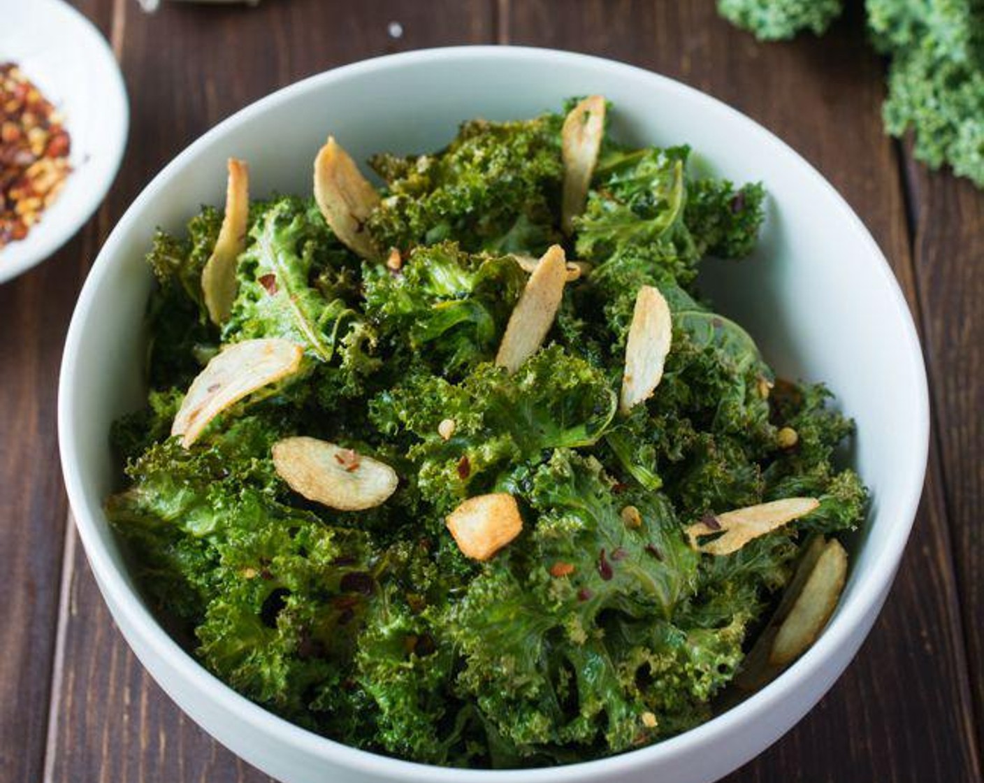 step 6 Bake for 18 to 20 minutes or until crispy. Transfer the kale chips to a bowl, then top with the garlic chips and more crushed red pepper, if desired.