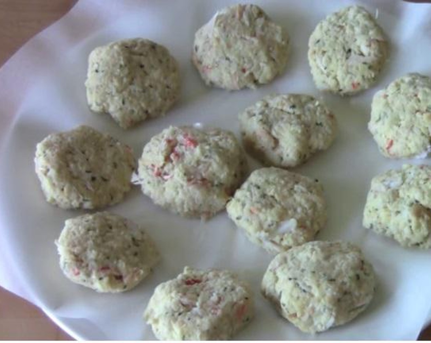 step 2 Into the same mixing bowl, also add the Fresh Crab Meat (2 cans), and Breadcrumbs (2 cups). Stir everything together. Shape the mixture into small patties and put them on a plate. Put the small patties inside a fridge for about 20 minutes