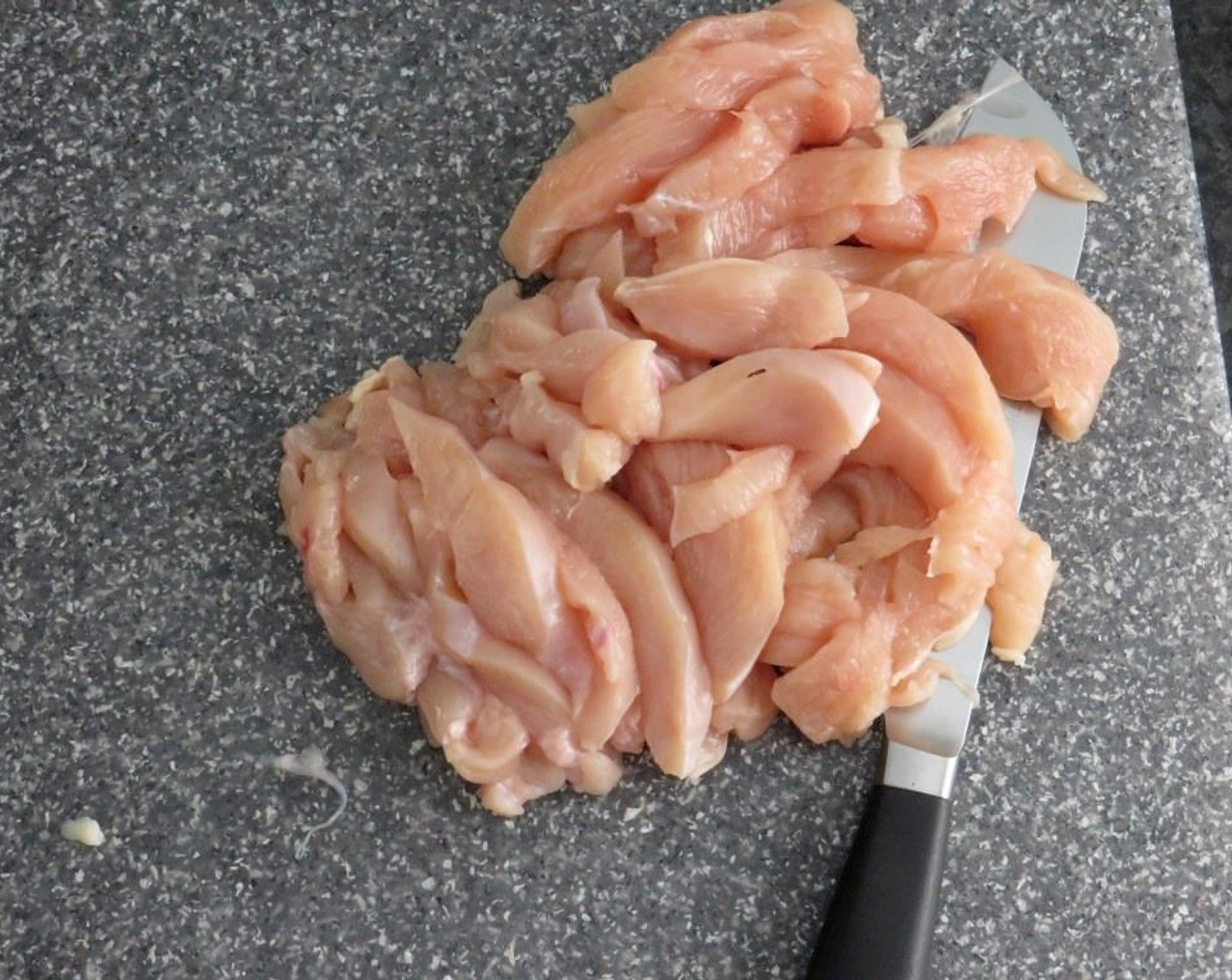step 8 Slice the Boneless, Skinless Chicken Breast (1 lb) crosswise into 1/4 inch slices, and heat Olive Oil (2 Tbsp) in a skillet over medium high heat.