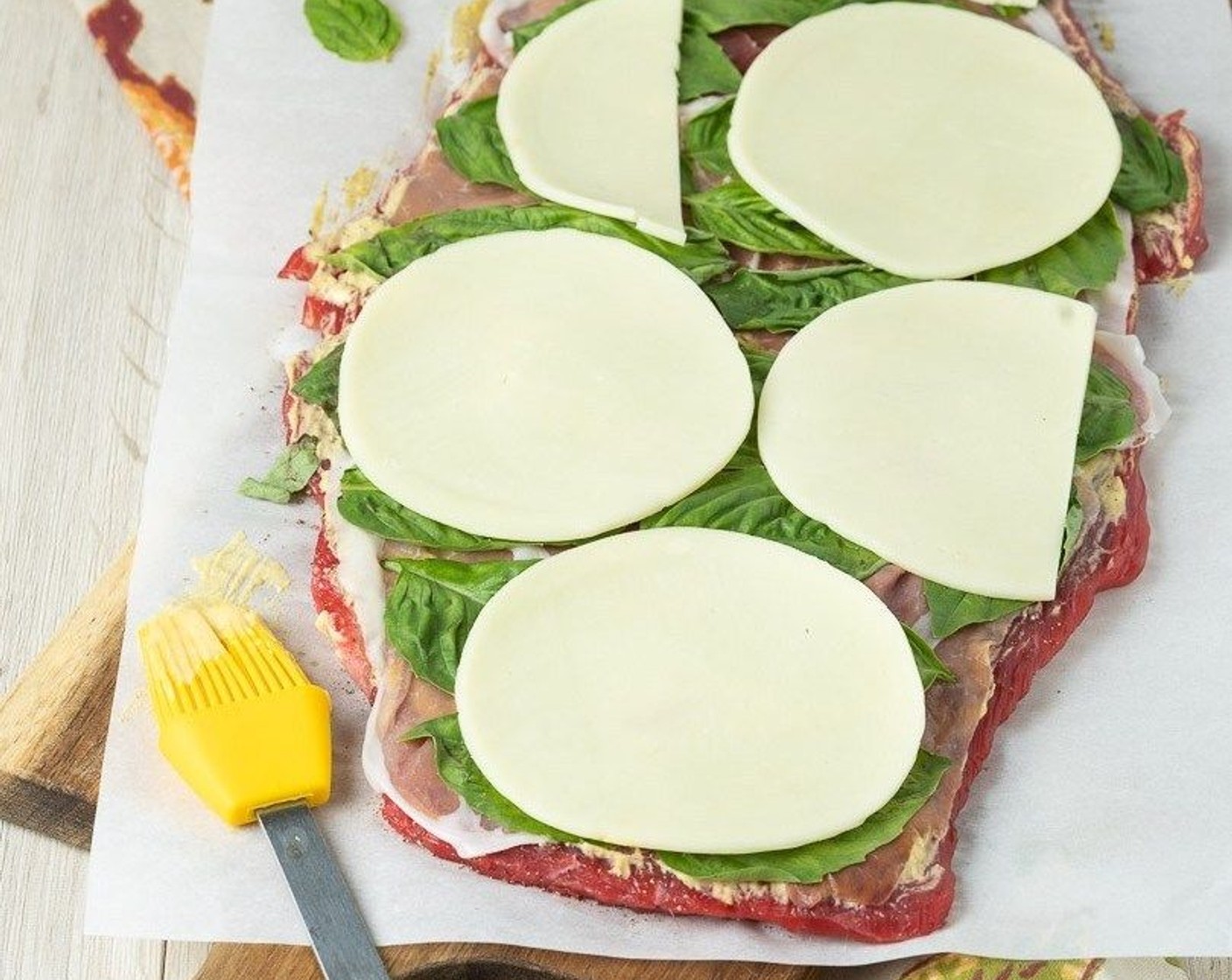step 4 Cover with Prosciutto (3 slices) slices in an even layer. Arrange Fresh Basil Leaves (18) in a single layer on top of the prosciutto. Top with an even layer of Provolone Cheese Slices (4).