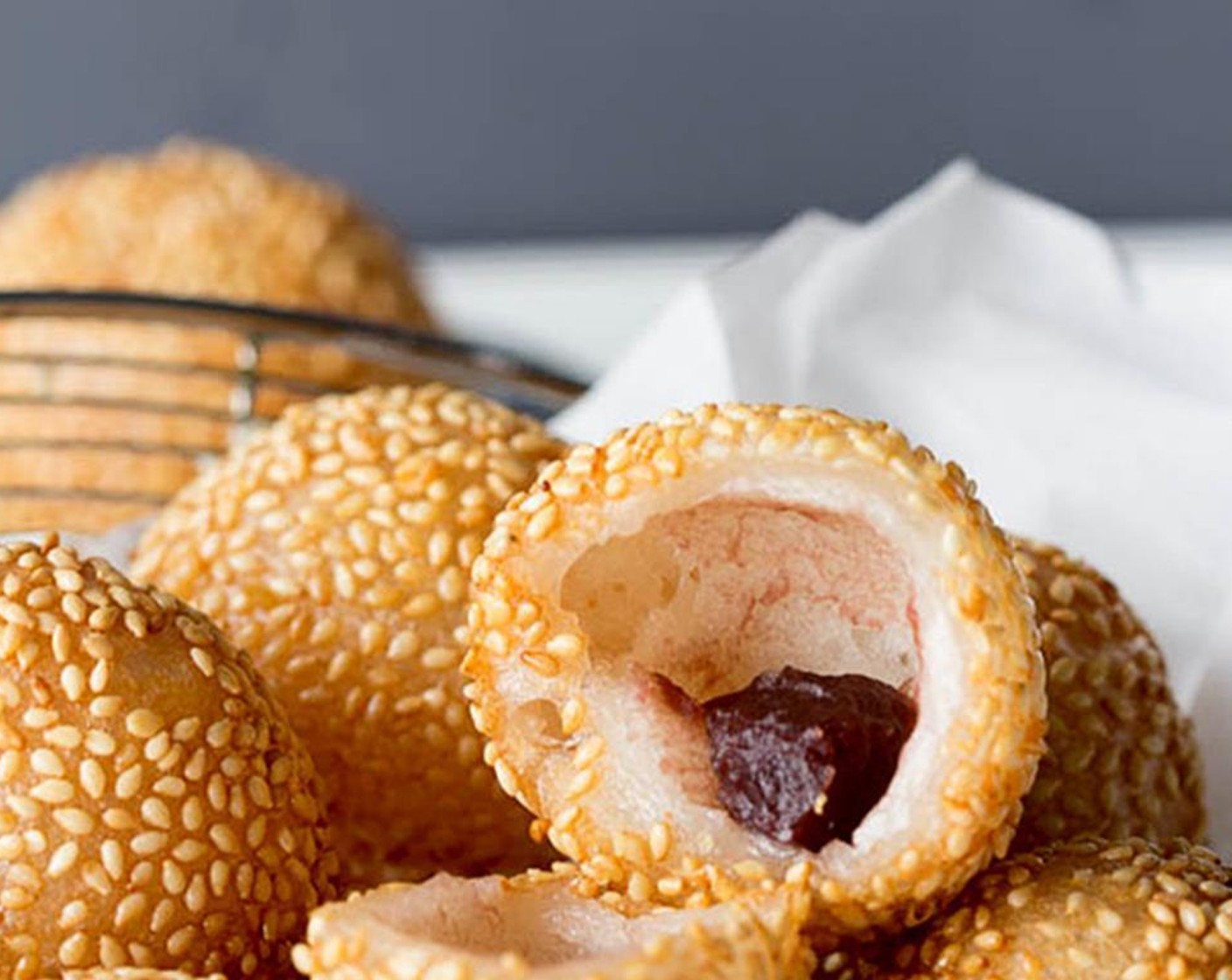 step 7 In a large pot, heat enough Canola Oil (as needed) until 120 degrees C (50 degrees F). Carefully add in the sesame balls, and lower the heat immediately to slowly deep-fry the balls until slightly golden brown. Transfer out and absorb extra oil with kitchen napkins. Let cool down and enjoy!