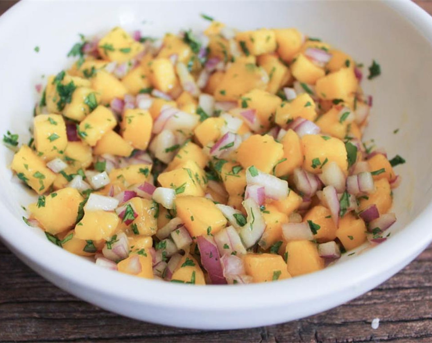 step 2 Start by preparing the mango salsa. In a medium bowl, combine Mango (1), Red Onion (1/2 cup), Fresh Cilantro (2 Tbsp), Lime (1). Let sit at room temperature for 30 minutes.
