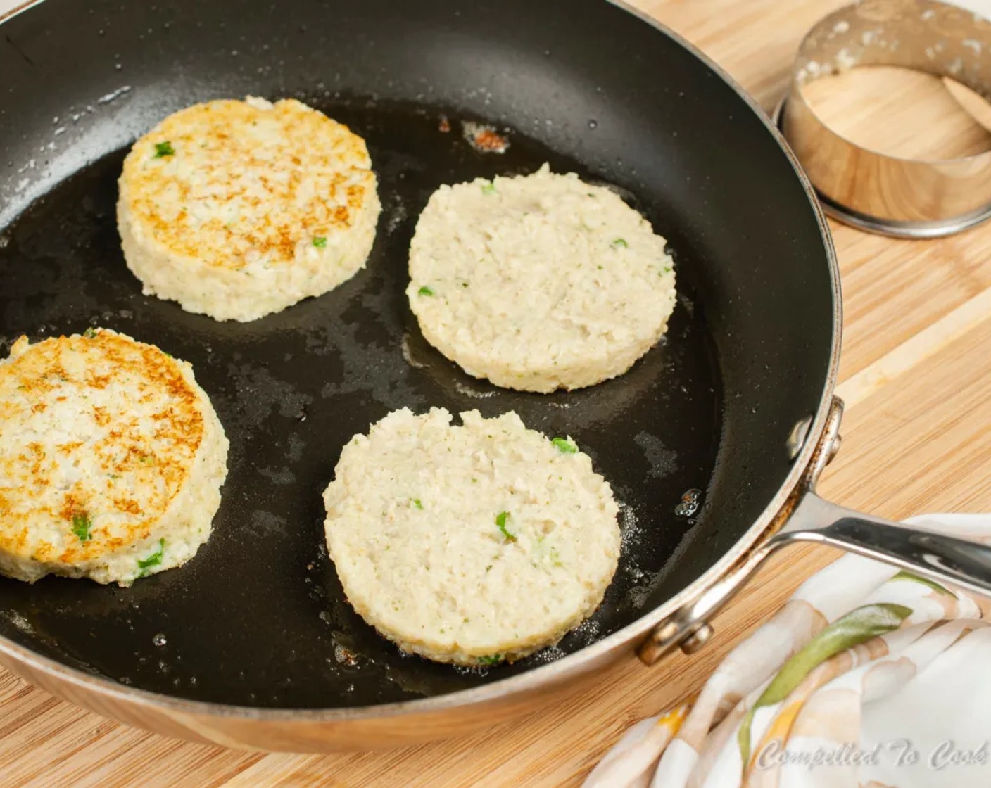 step 6 Using approximately 1/4 cup of cauliflower mixture, form into patties by scooping into a 3 inch ring mold set in the bottom of the pan and flatten with a spoon. Remove the ring mold and repeat for remaining cakes.