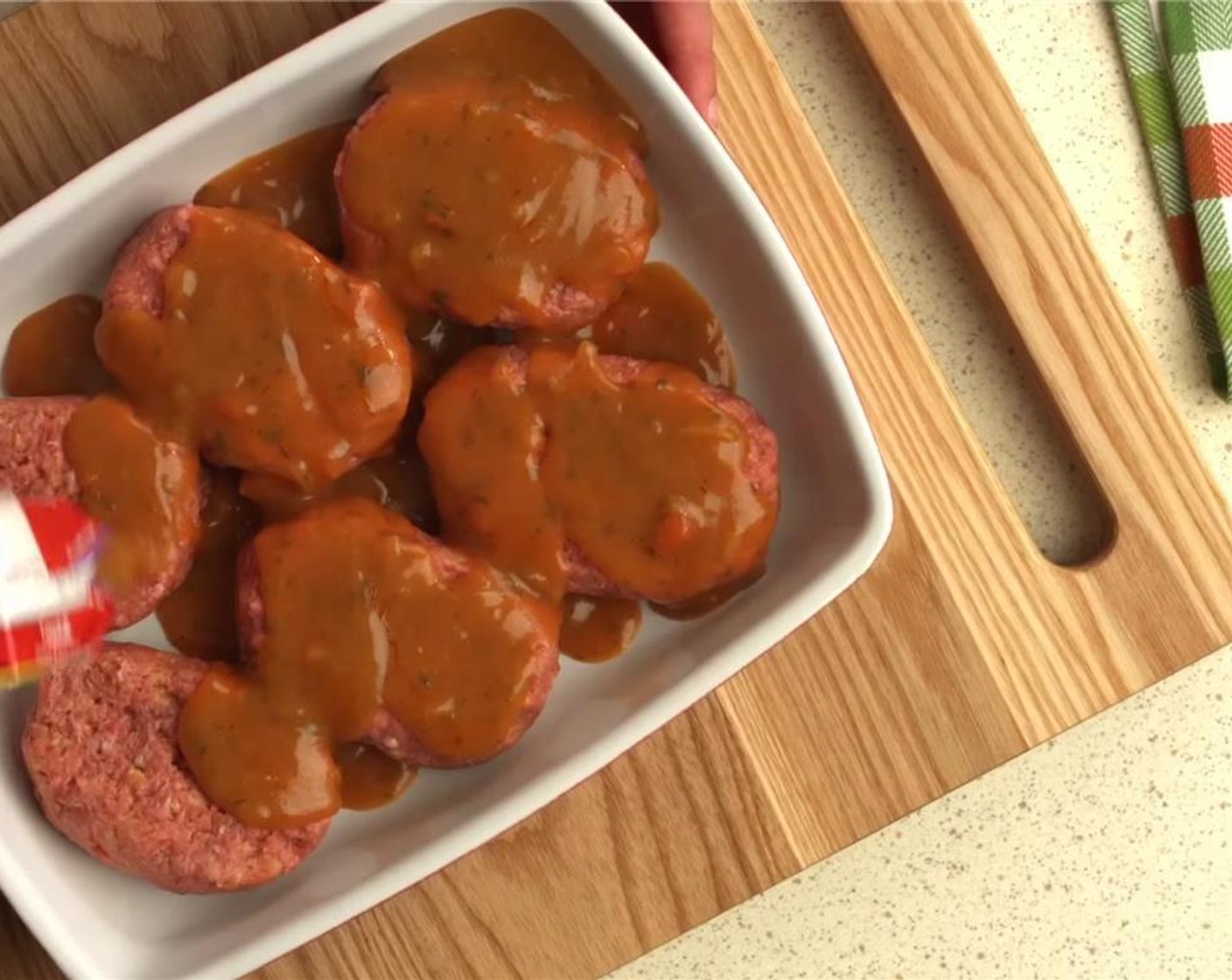 step 6 Place the mini meatloaves into a 13x9x2-inch baking dish. Pour the remaining soup over the meatloaves.