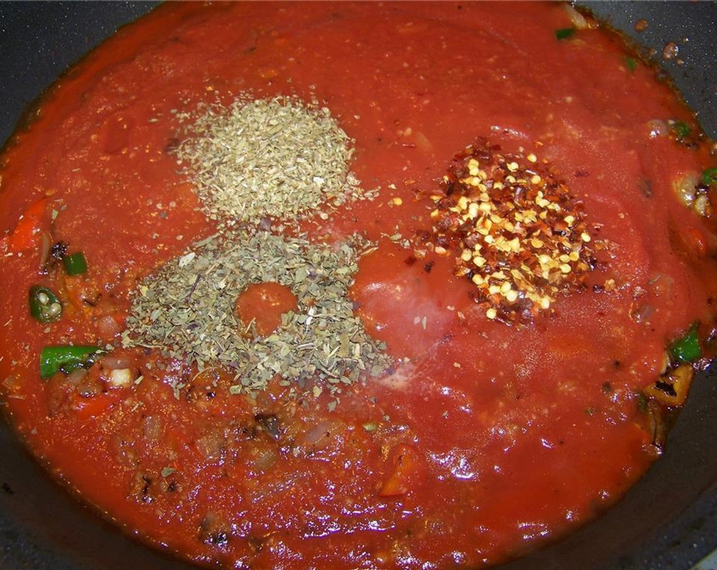 step 7 Then add the Crushed Red Pepper Flakes (to taste), Dried Basil (1 tsp), Dried Oregano (1 tsp), Canned Crushed Tomatoes (3 1/3 cups), and season with salt and pepper.
