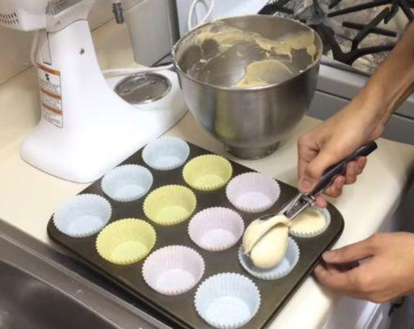 step 2 Onto a muffin tin lined with cupcake paper, add a scoop of the batter into each liner paper. Bake them under 350 degrees F (180 degrees C) for about 20 minutes.