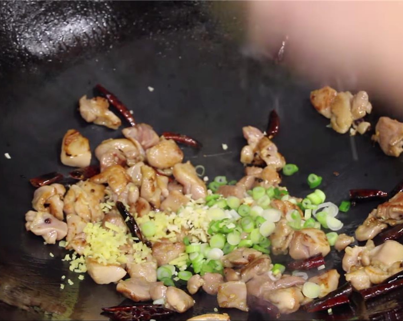 step 17 Add in the white part of the green onion, garlic and ginger. Stir fry for about 20 to 30 seconds.