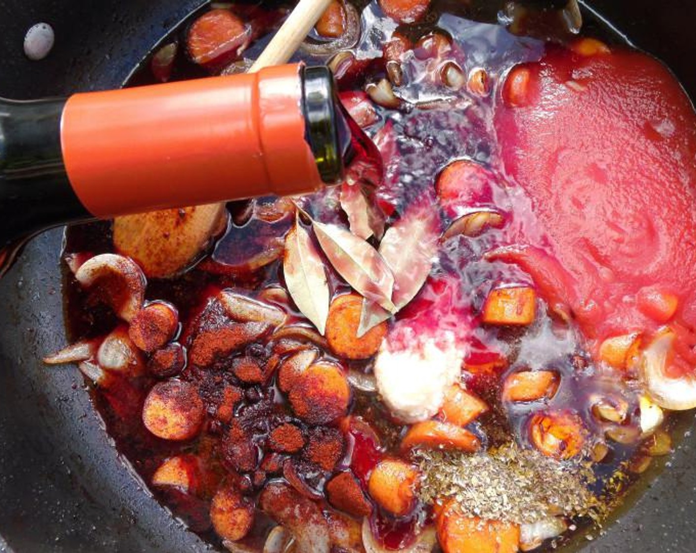 step 4 Add Merlot (3 cups), Canned Tomato Purée (1 cup), Bay Leaves (3), Garlic Paste (1 Tbsp), Fresh Oregano (1 tsp), and Kosher Salt (to taste) and Cayenne Pepper (to taste).