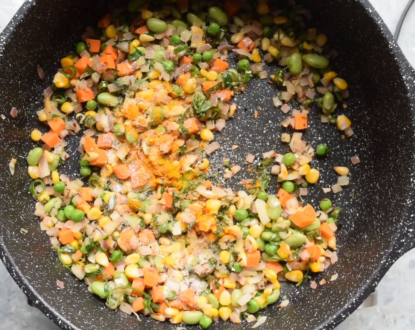 step 4 Next, add Mixed Vegetables (1 cup) along with Salt (to taste) and Ground Turmeric (1 tsp).