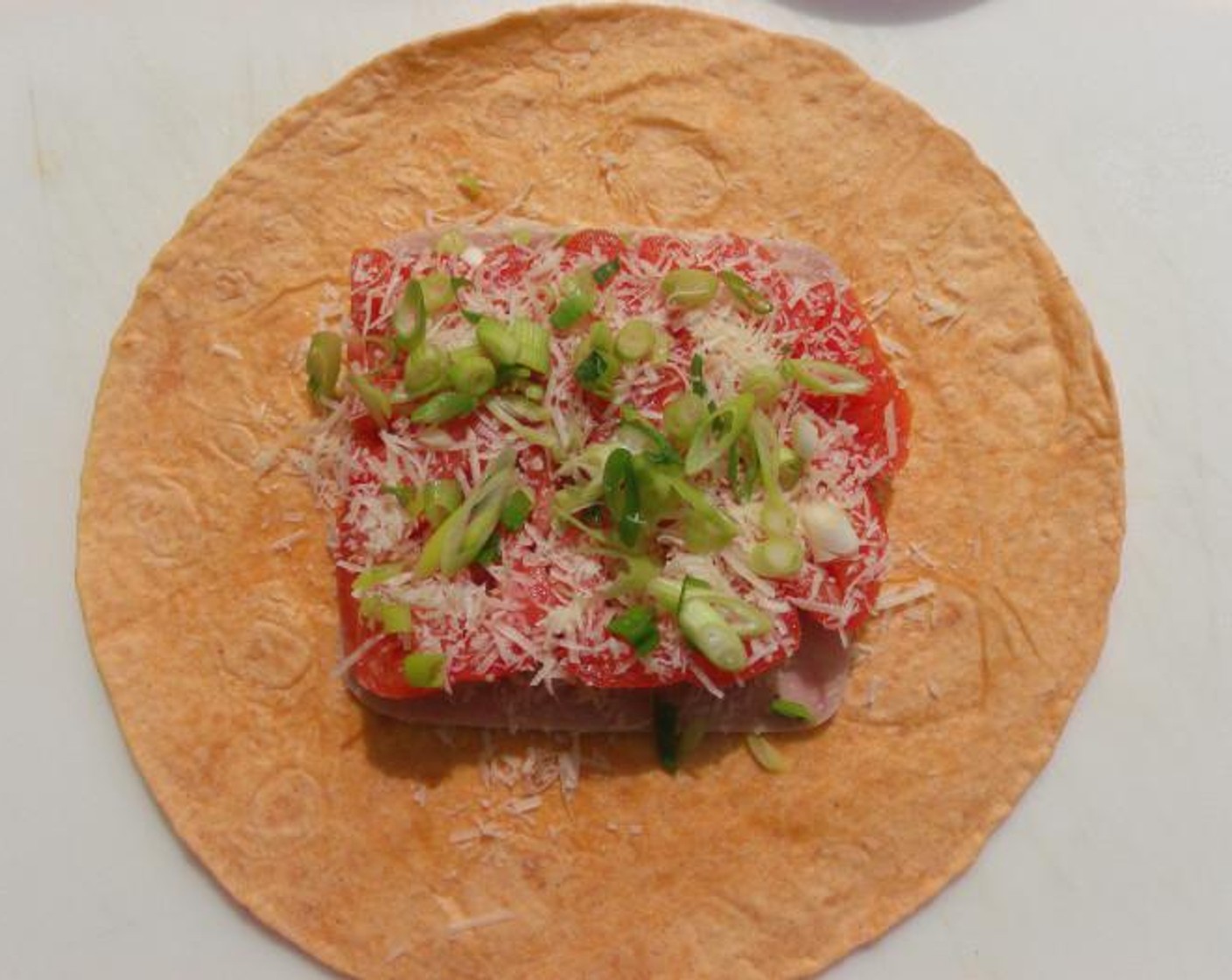 step 3 Add Tomato (1 slice). Sprinkle with Grated Parmesan Cheese (1 pinch) and Scallion (1 pinch).