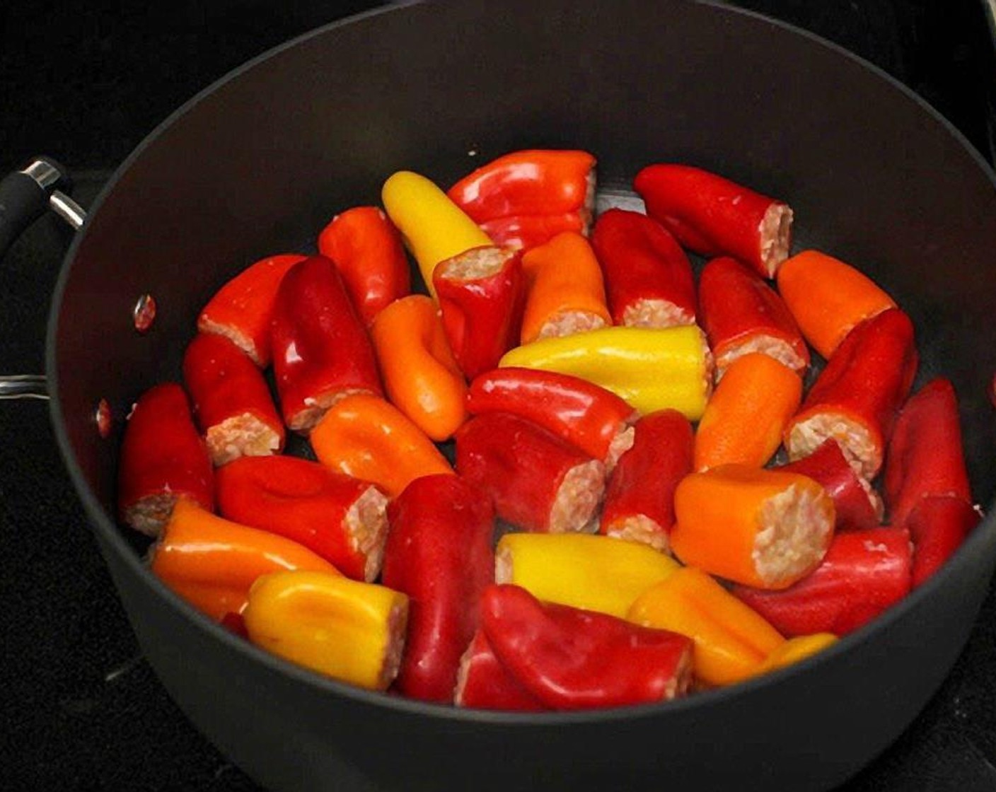 step 8 In a large pot or skillet, heat up 1 tablespoon of Olive Oil (1 Tbsp) on medium high heat. Add the peppers and sear for about 2 minutes per side. If all your peppers don't fit in one layer, switch the peppers.