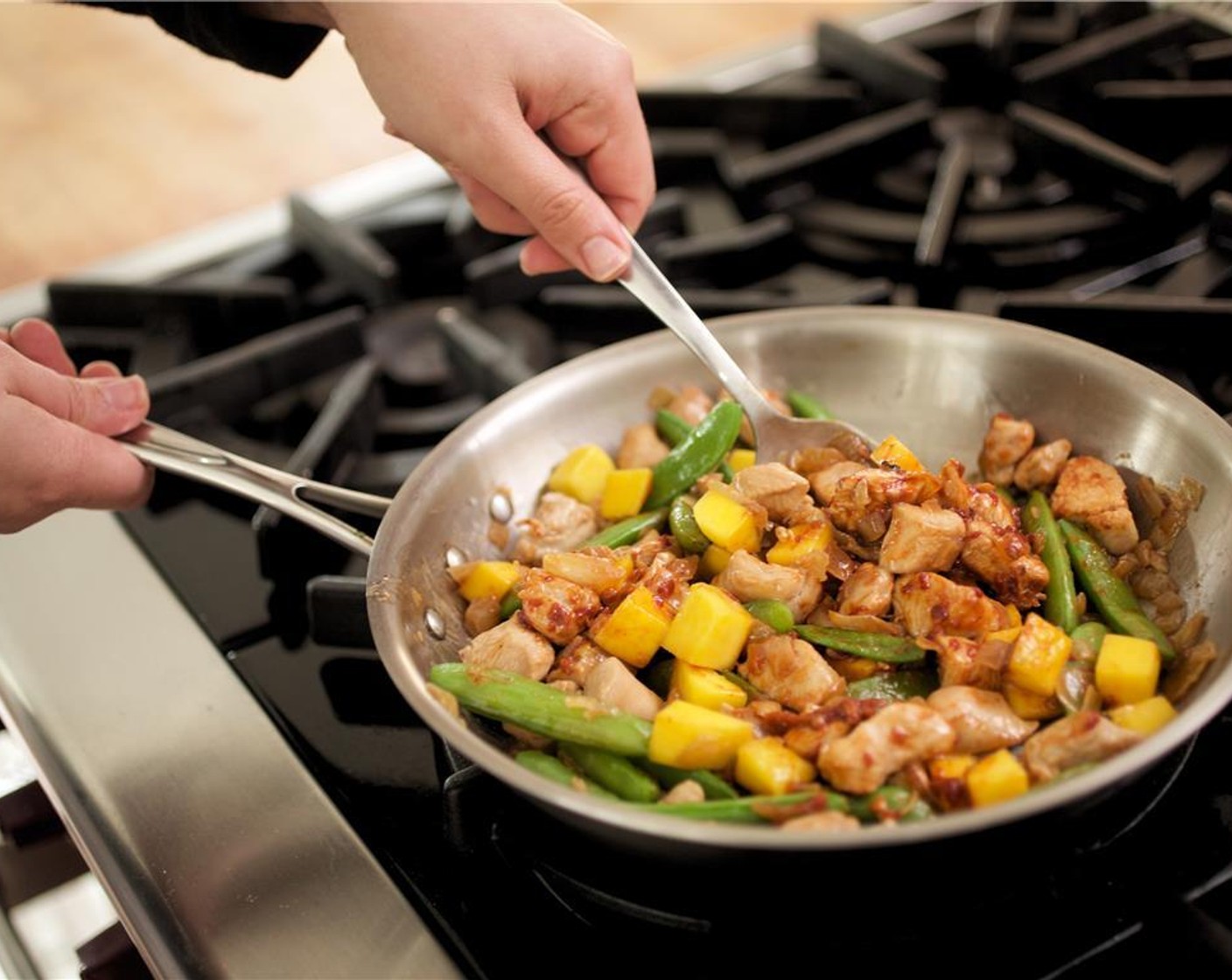 step 11 Add the mango and Sambal (1 Tbsp). Cook chicken for 1 more minute.