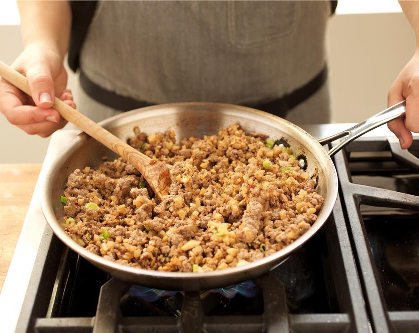 step 11 Add Water Chestnuts (1/2 cup), scallion, Sesame Oil (1/2 Tbsp) and cooked beef to the pan. Cook and stir until the green onions begin to wilt, about one minute.