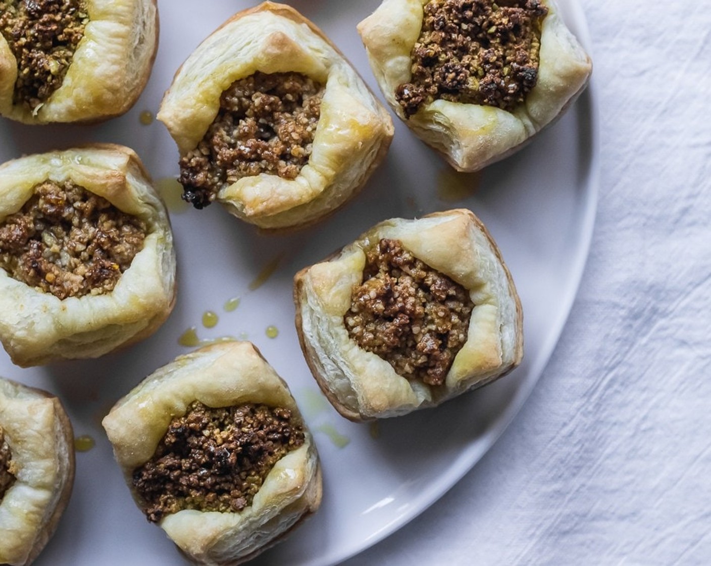 step 7 When baklava is done baking, immediately remove the baklava pieces from the muffin pan & onto a serving platter.