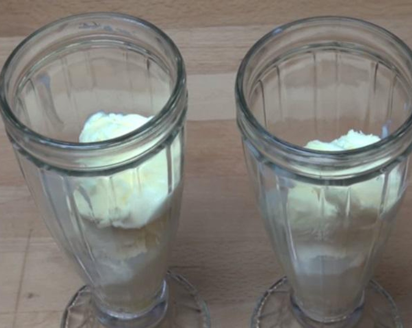 step 1 Scoop in the Vanilla Ice Cream (4 scoops) into two milk shake glasses.