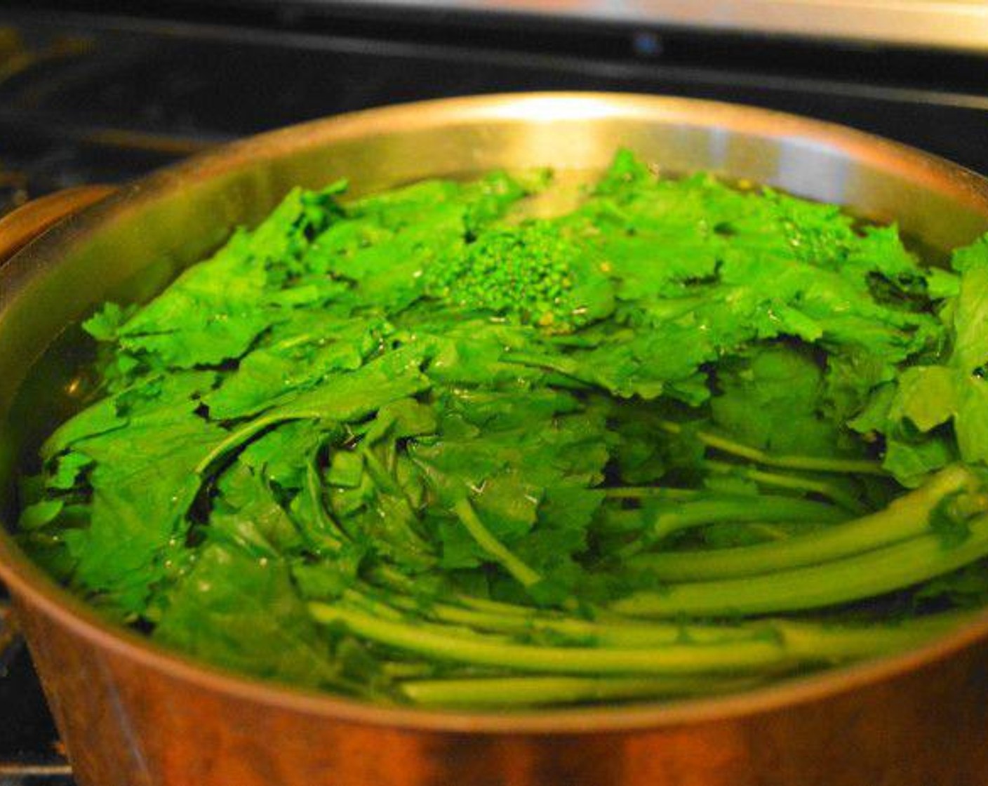 step 1 Get a large pot of water on the stove to boil and salt it generously. Have a large bowl of ice water handy. Let the Broccoli Rabe (1 bunch) boil in the pot for a minute.