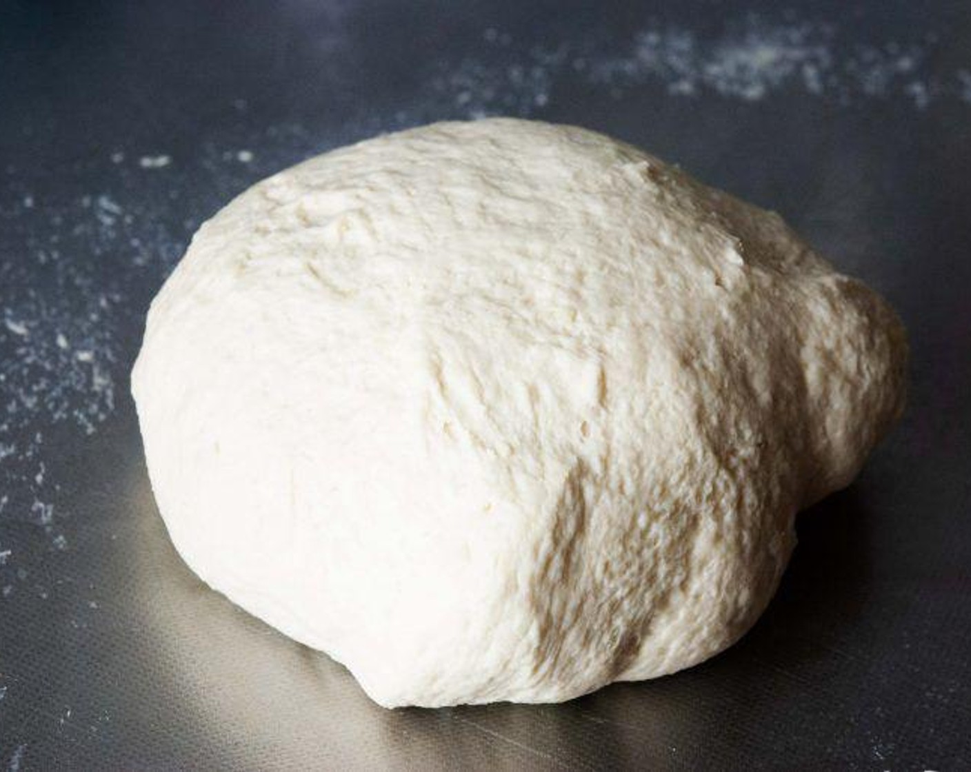 step 3 Add in the Extra-Virgin Olive Oil (3 1/3 Tbsp) then pour the wet ingredients into the dry one and mix on medium- low for 5 min or until the dough comes together and it’s not sticking on the side of the bowl. Turn it onto your kitchen counter and knead it by hands for 5-10 more minutes.