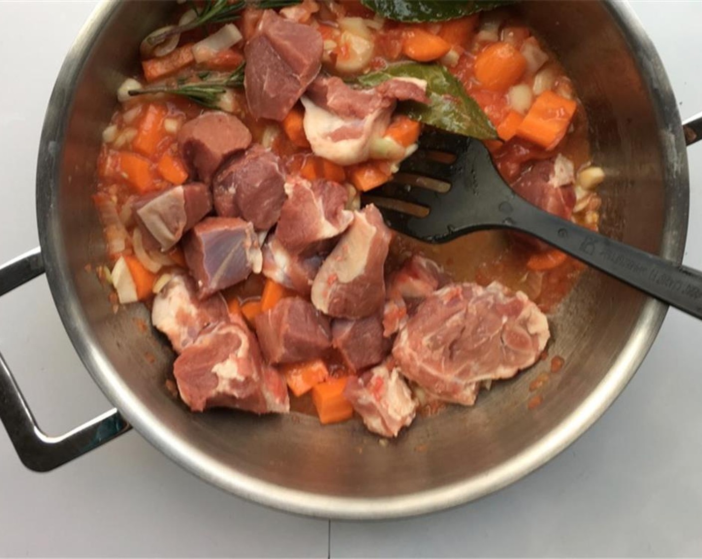 step 3 Stir well and let the ingredients simmer for 3 minutes. Chop up the Lamb Shanks (1.7 lb) into smaller bits and add them to the casserole.