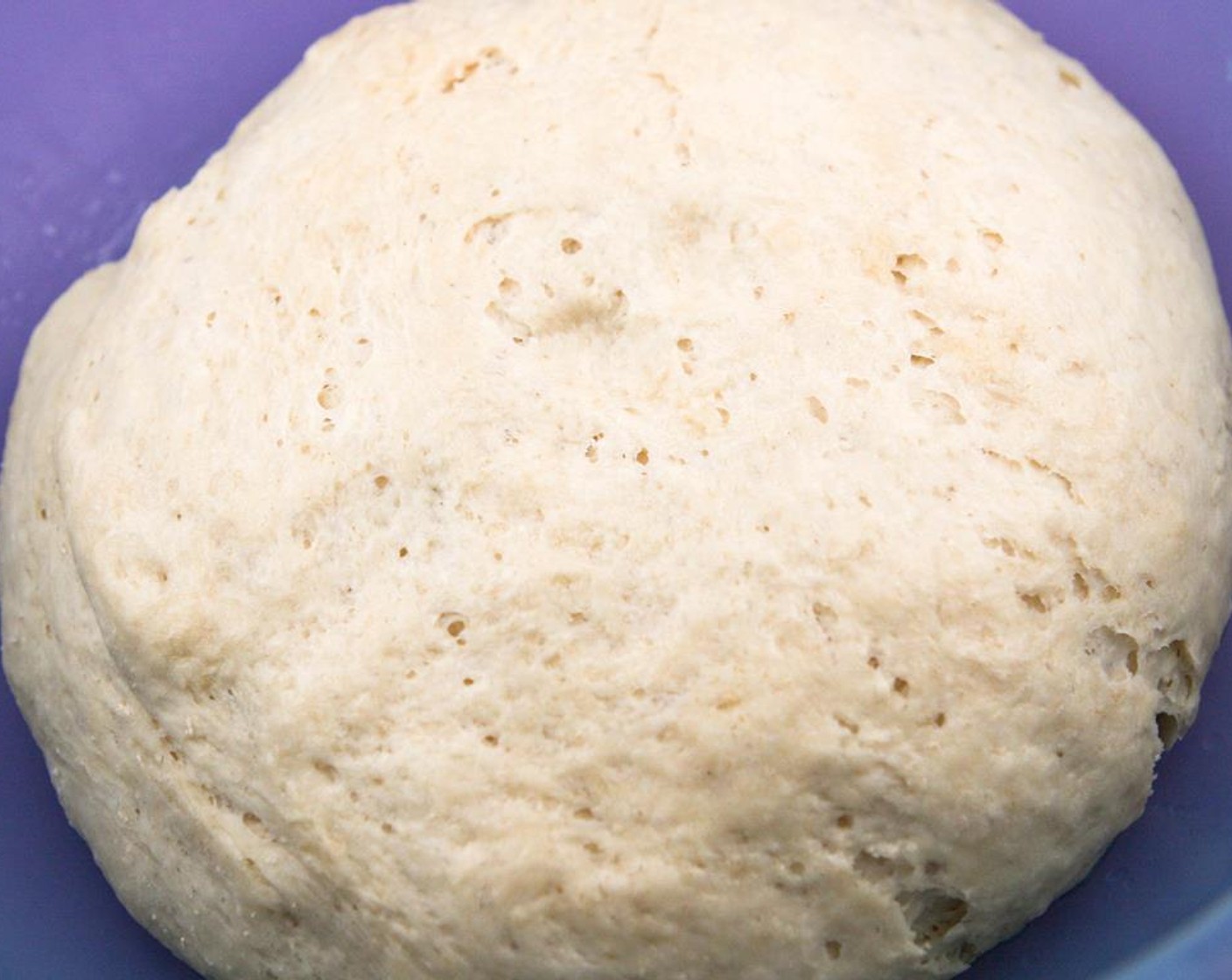 step 3 Brush the inside of a large bowl with olive oil. Move the dough to the bowl and cover tightly with plastic wrap. Allow to rise in a warm, draft-free area for about 2 hours, until dough has doubled in size and bubbles appear on the surface.