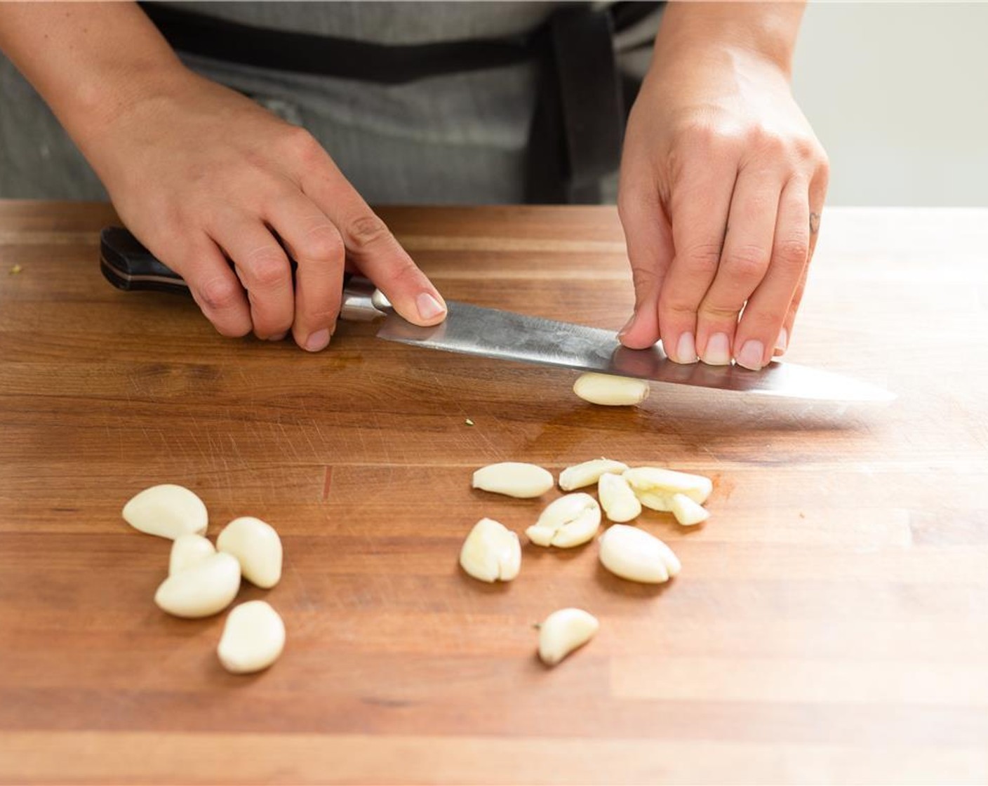 step 3 Pressing down with the flat side of the knife, smash the Garlic (20 cloves) and set aside.