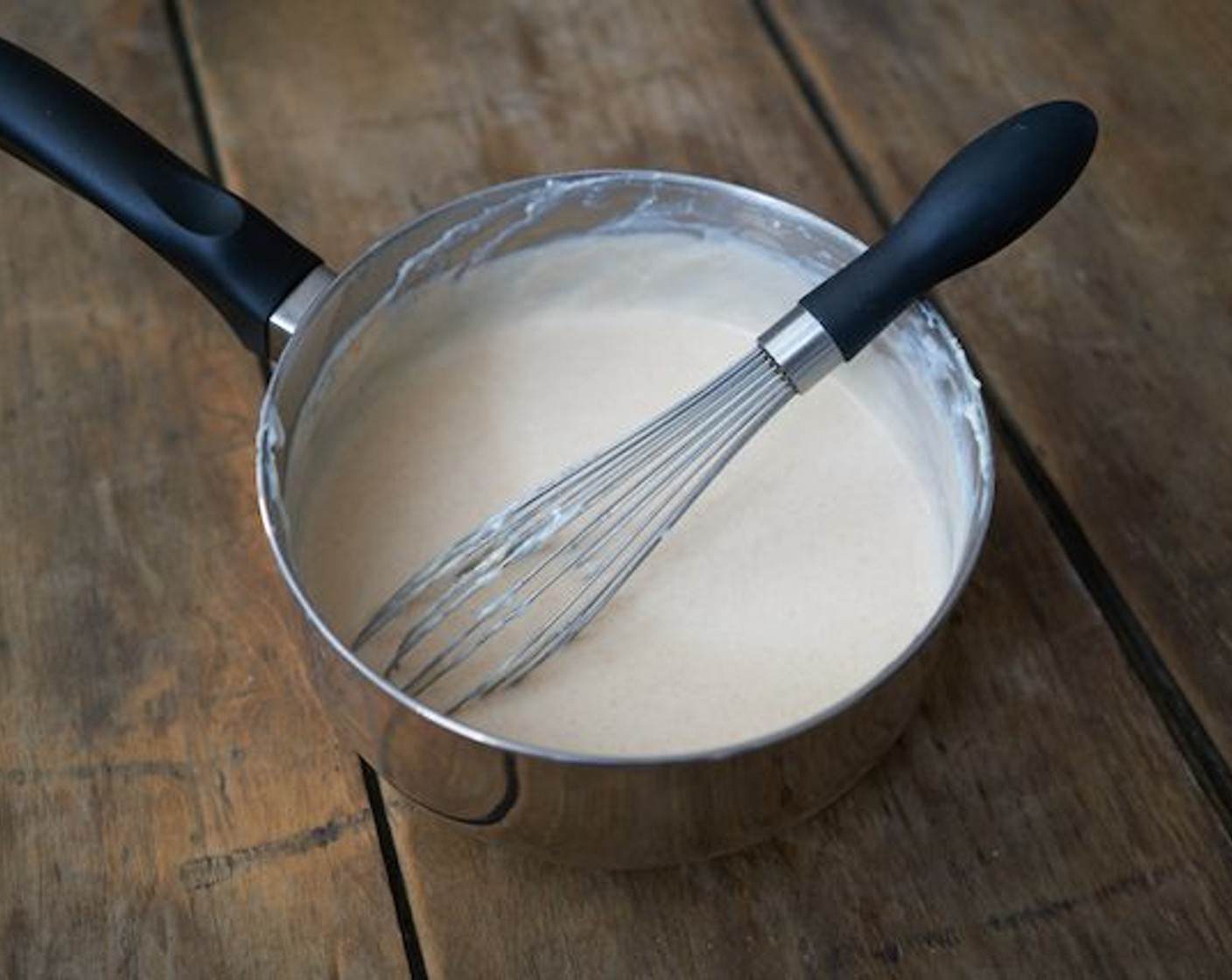 step 7 Gradually add the milk, still whisking constantly to avoid any lumps. Once all milk is incorporated, bring it to a low boil and continue to whisk occasionally as it thickens, 4–5 minutes.