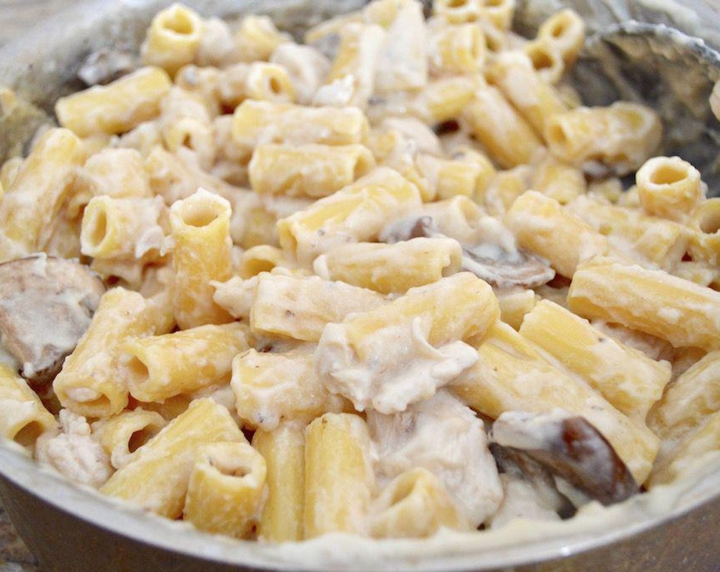 step 6 Then drain the pasta and add it to the pan of sauce, along with the chicken. Let everything gently simmer together for another couple of minutes while you stir it together thoroughly.