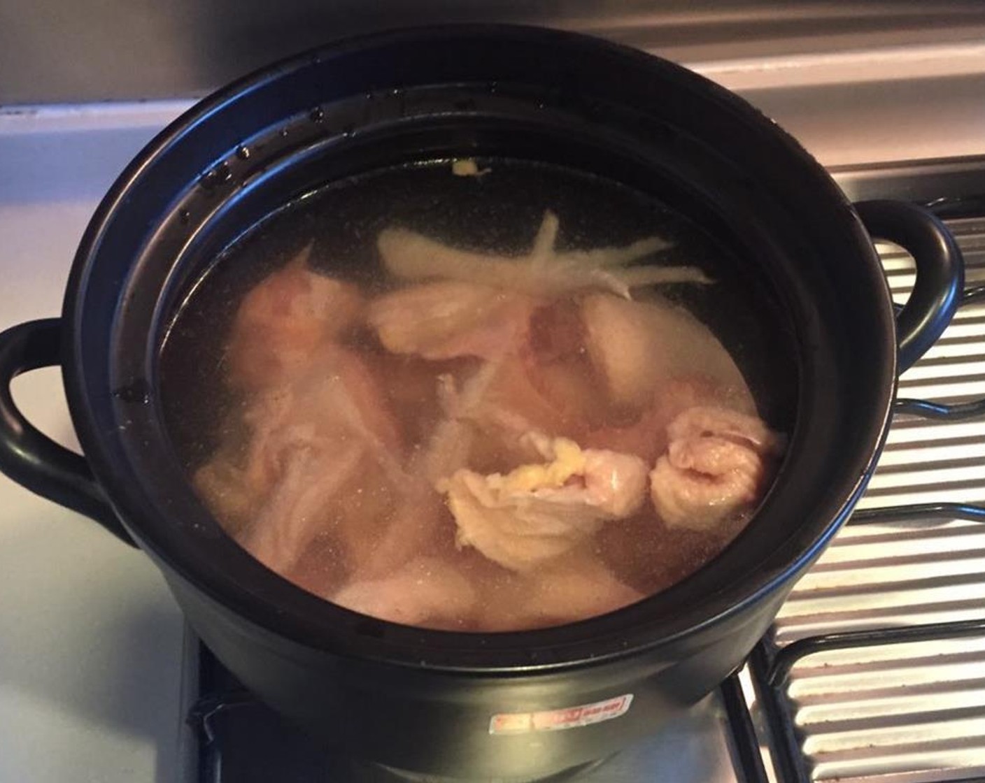 step 4 In a clay pot or dutch oven filled with water, cook the chopped chicken pieces under high heat.