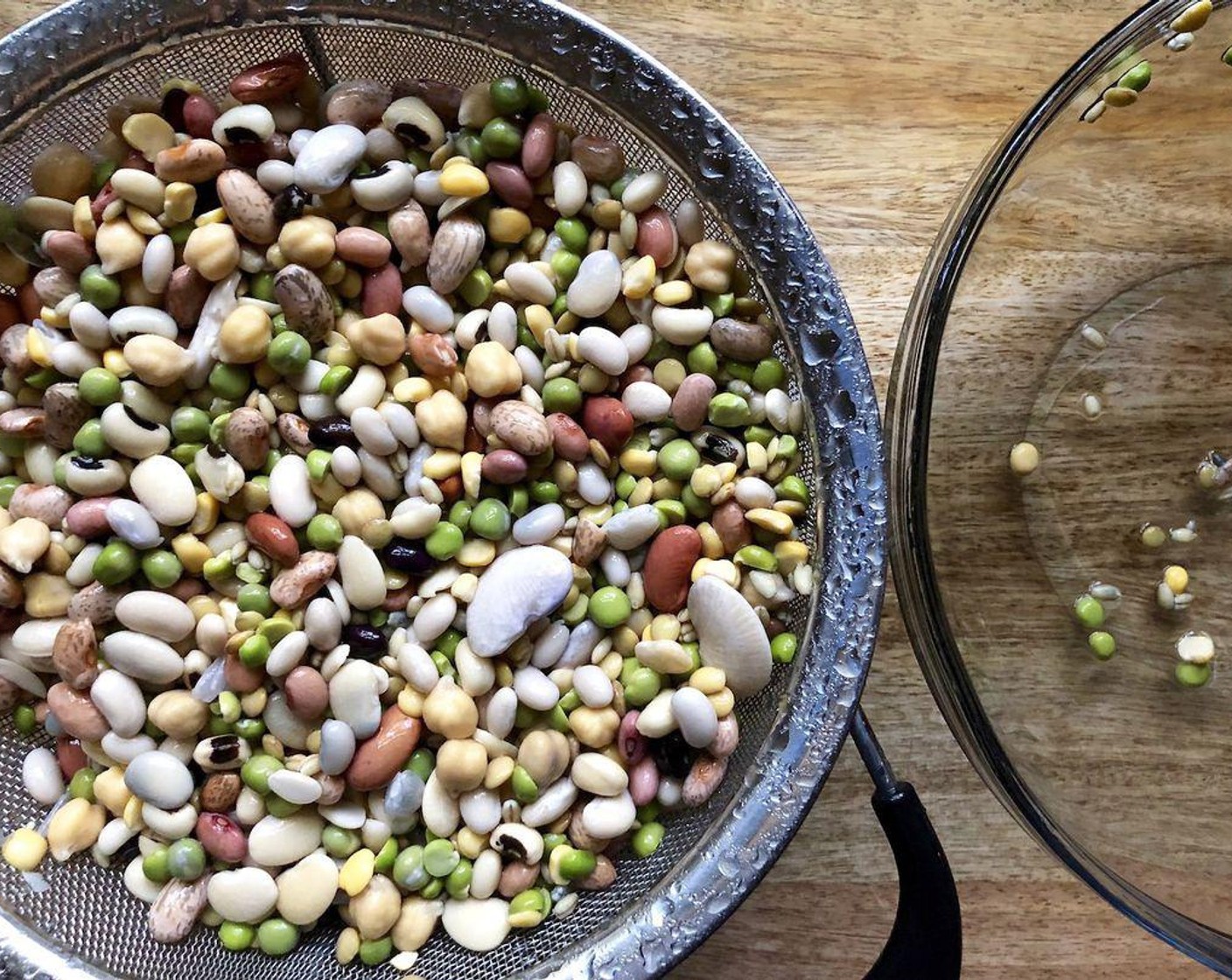 step 2 The next day, drain the beans, rinse under cold running water and drain again. Place the beans in a large pot with 8 cups of cold water. Bring to a boil, lower the heat and simmer for 1 hour. Stir occasionally and skim off any foam that rises to the top. The beans should be very tender and the skin will peel away when you blow on a bean.