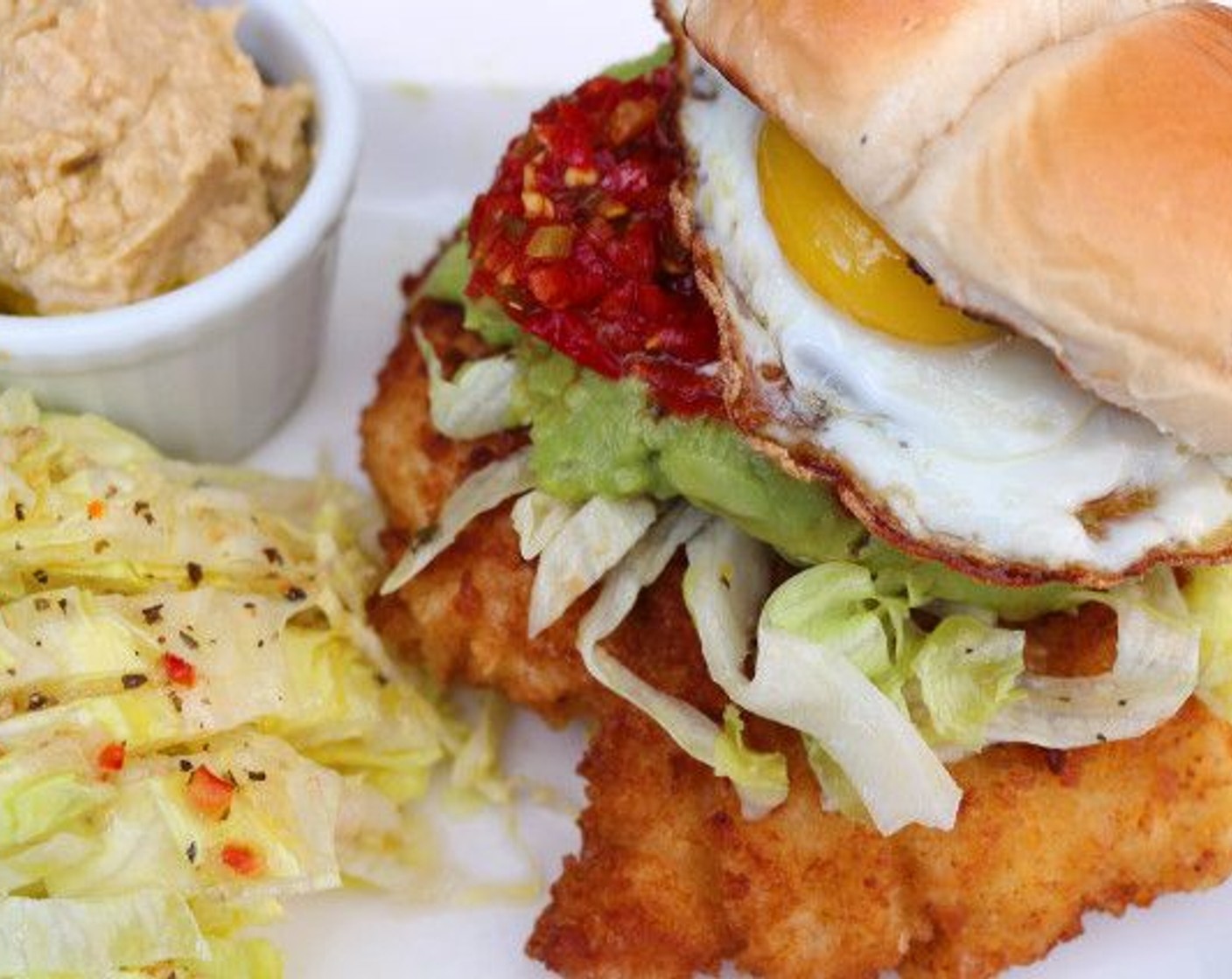 step 12 Top chicken with Guacamole (to taste), Hot Chili Relish (to taste), Lettuce (to taste) and fried egg. Finally, add top half of bun.