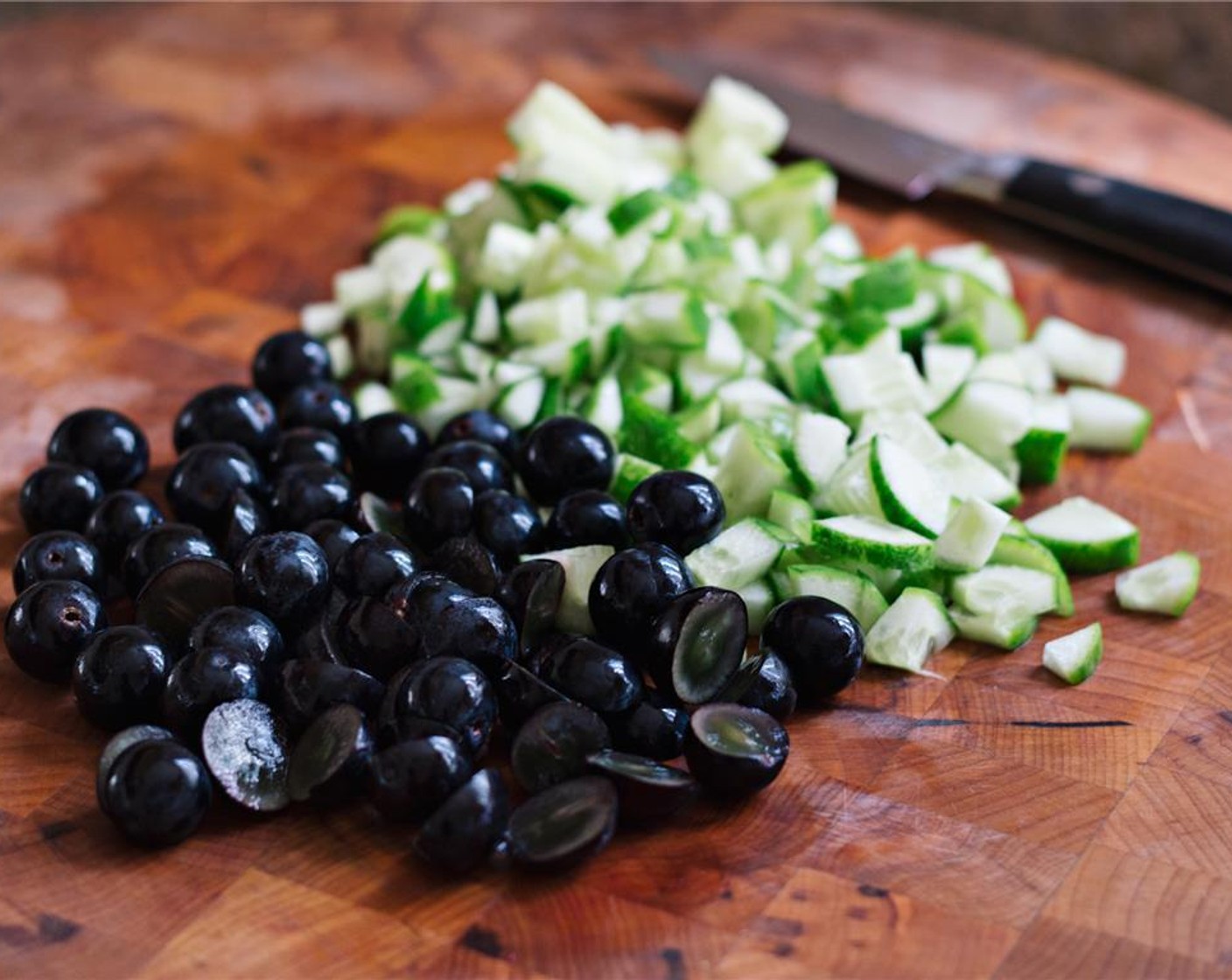 step 3 Slice the Black Grapes (1 cup) in half and chop the Persian Cucumbers (2).