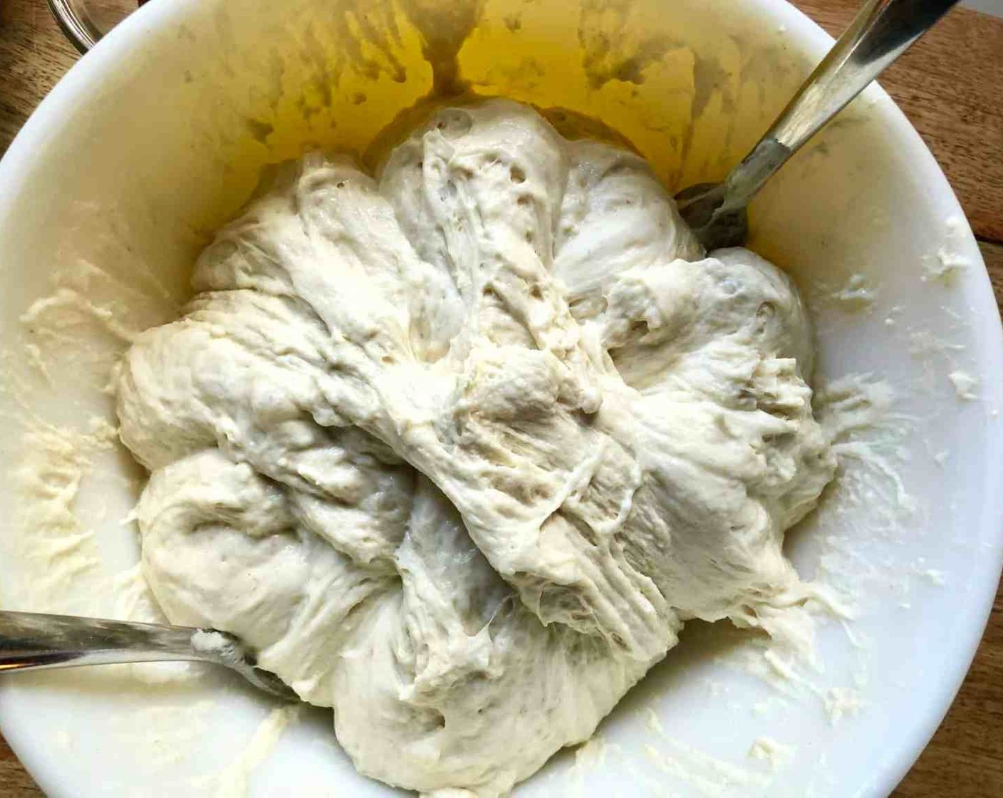 step 9 Using two forks, deflate the dough by releasing it from the sides of the bowl pulling it toward the center. Rotate the bowl quarter turns as you deflate, turning the mass into a rough ball.