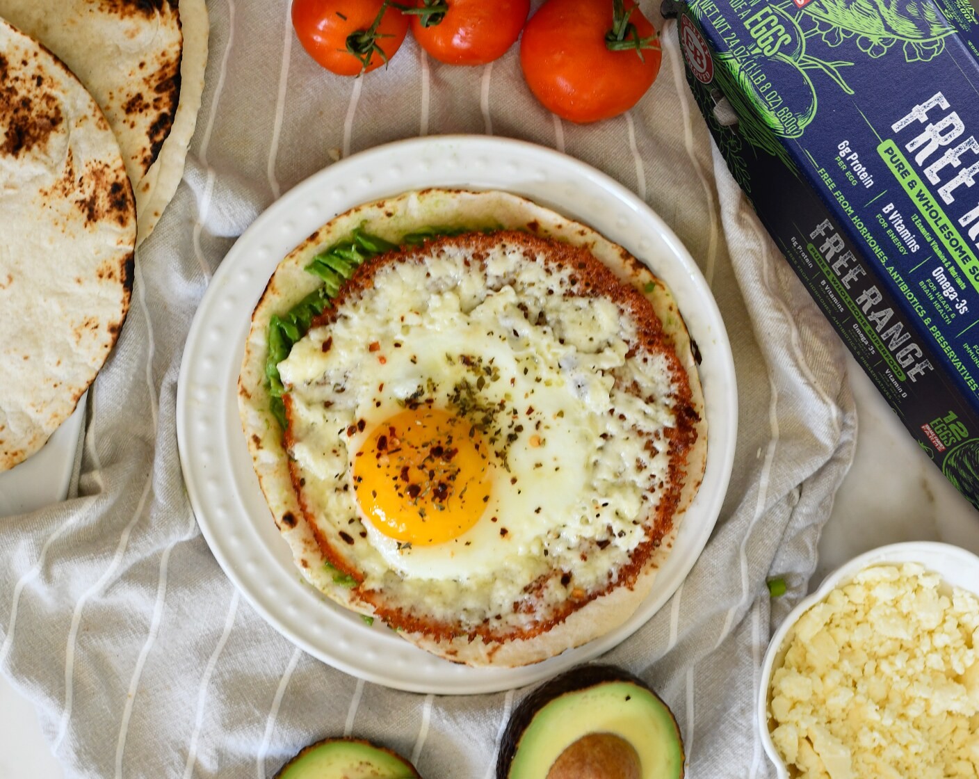 step 4 Cook until the feta turns golden/brown and the egg is cooked to your preference, medium or runny.
Warm the Flour Tortilla (1) on a gas stove or pan. Top with the sliced Avocado (1/2), drizzle with Lime Juice (1 tsp), and smash with a fork. Carefully top with the fried egg and enjoy!