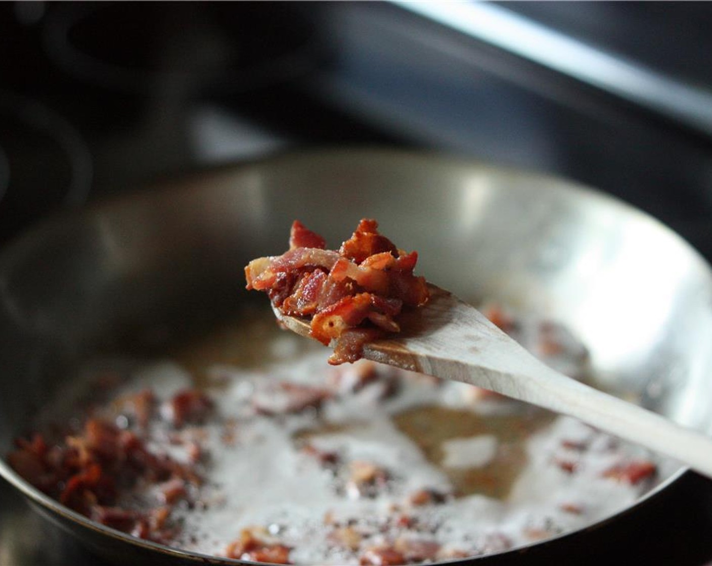 step 2 Cook bacon in a large frying pan over medium heat until the fat is rendered. Once it is crisp, use a slotted spoon to remove the bacon to a plate lined with paper towels.