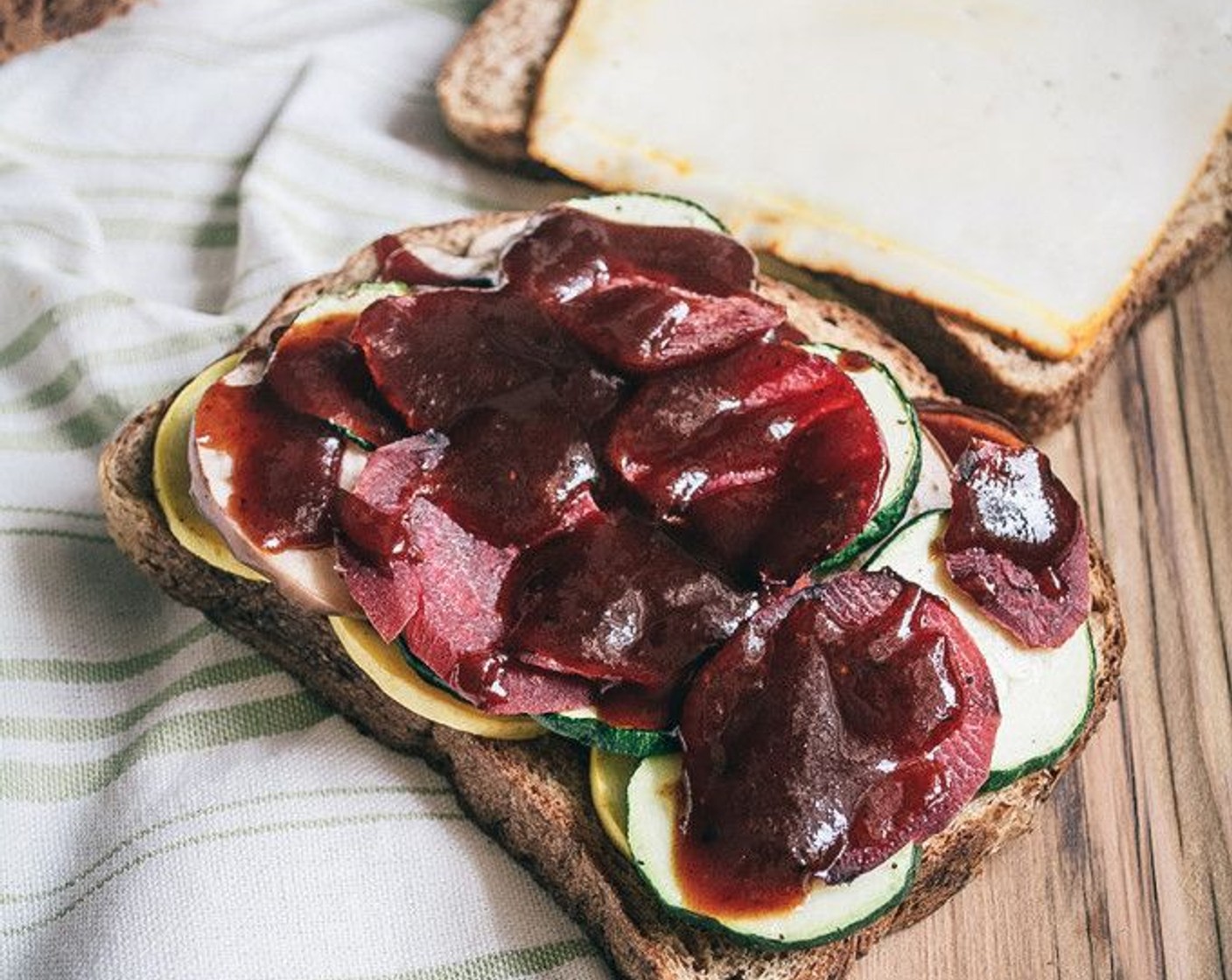 step 5 Layer roasted veggies on two pieces of Whole Wheat Sprouted Bread (4 slices). Coat with Barbecue Sauce (2 Tbsp), top with Muenster Cheese (2 slices).