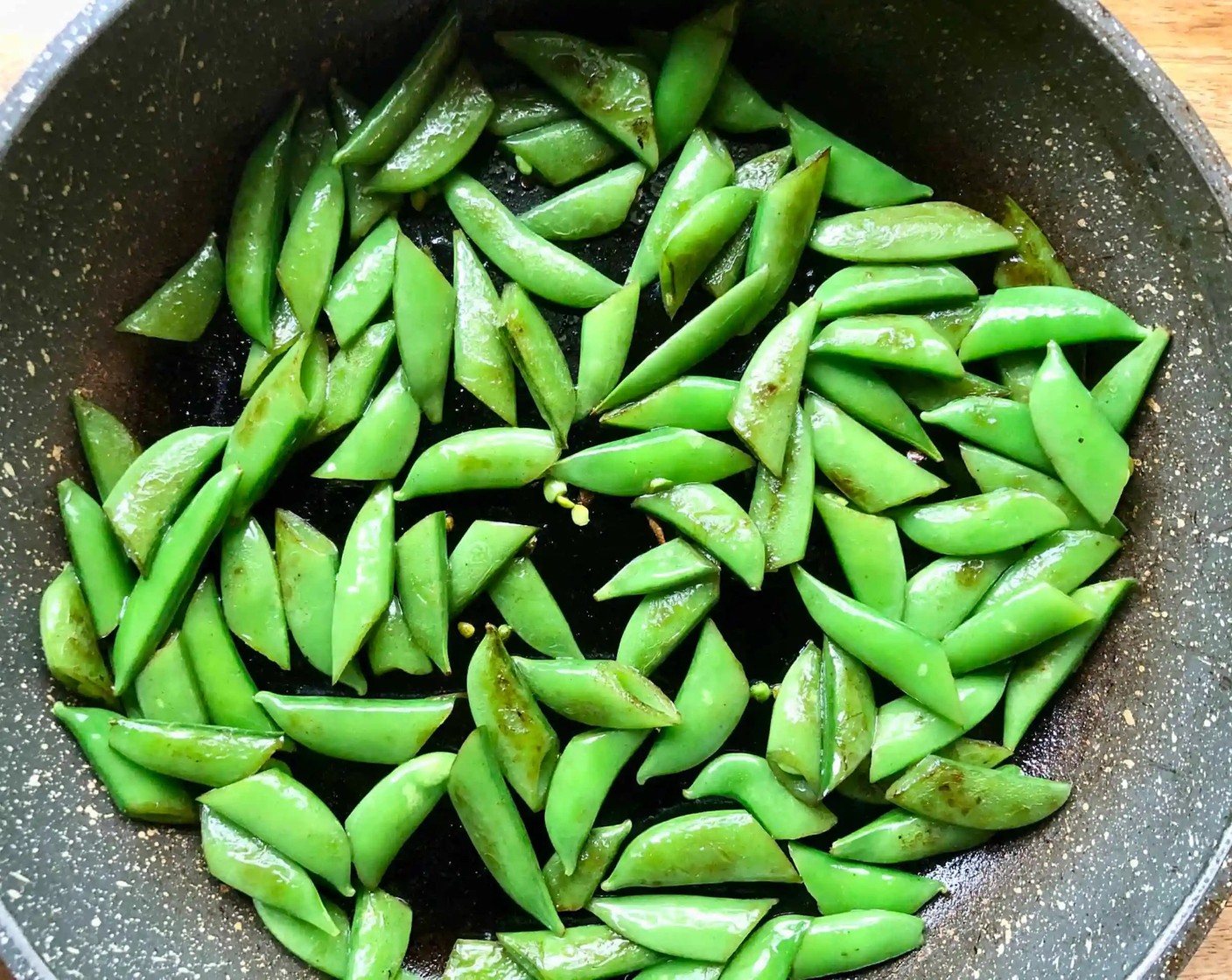 step 8 Heat a dry medium skillet, preferably cast iron, over high heat. Add Olive Oil (1 Tbsp), then add the Sugar Snap Peas (1 1/2 cups) so that they are spread out in a single layer. Cook, tossing once until charred on both sides, about 4 minutes. Transfer to a large bowl.