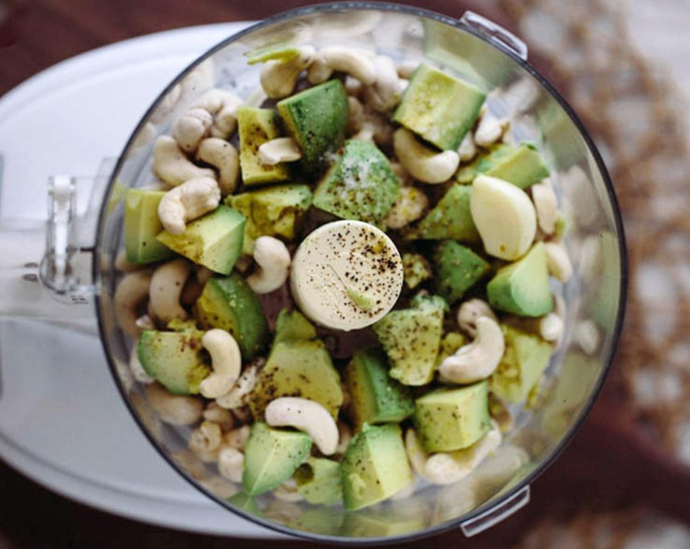 step 3 Drain the cashews and place them in the bowl of a food processor. Add Avocados (1 1/2), Garlic (1 clove), 2 Tbsp of juice from Lemon (1), Coarse Sea Salt (1 tsp), and Ground Black Pepper (1/4 tsp).