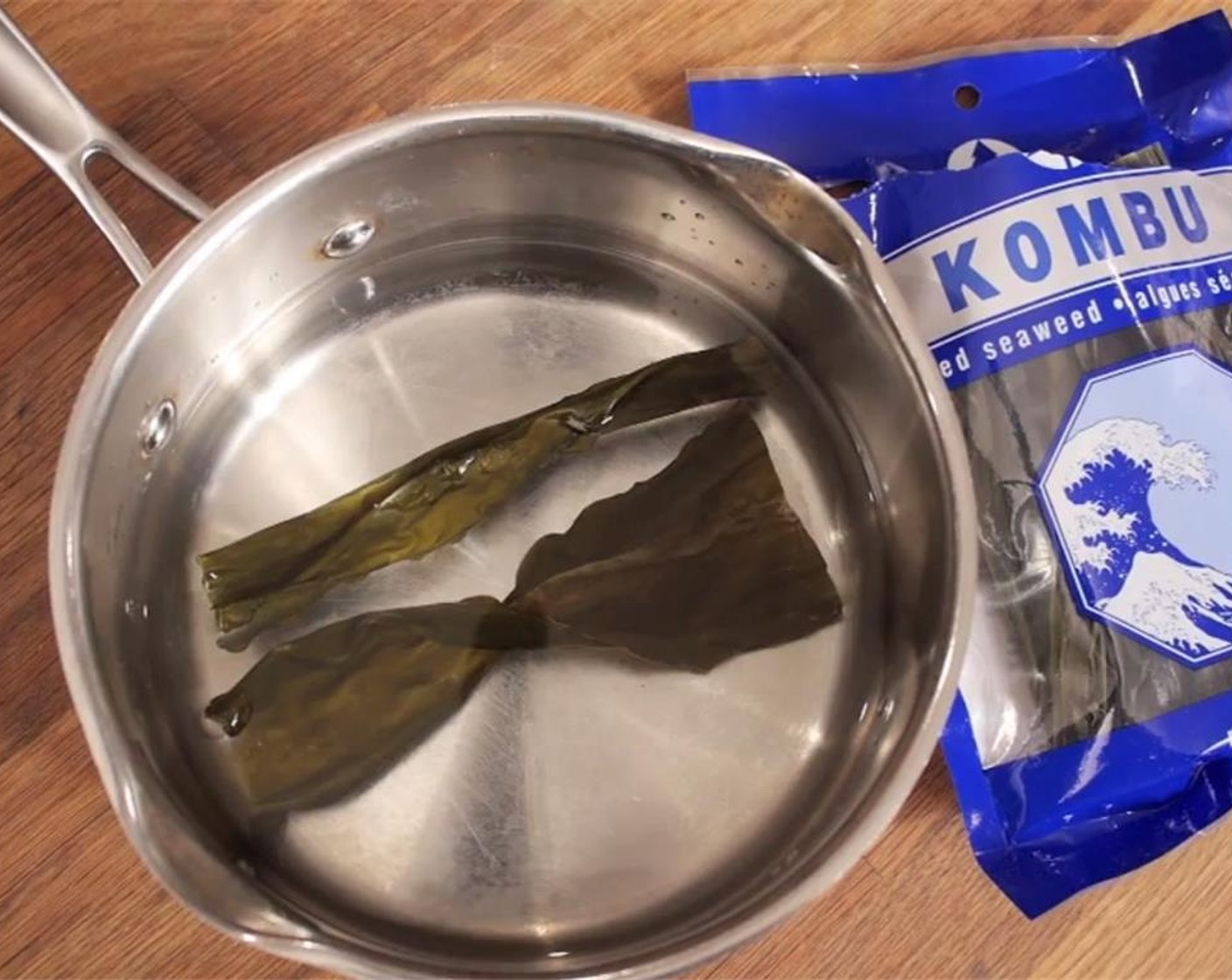 step 1 To make the dashi, add Water (4 cups) to a saucepan, and soak Kombu (2 sheets) for 30 minutes. Put saucepan on stove, and bring to a low simmer on medium heat. Once bubbles appear, remove kombu, and bring to a boil.