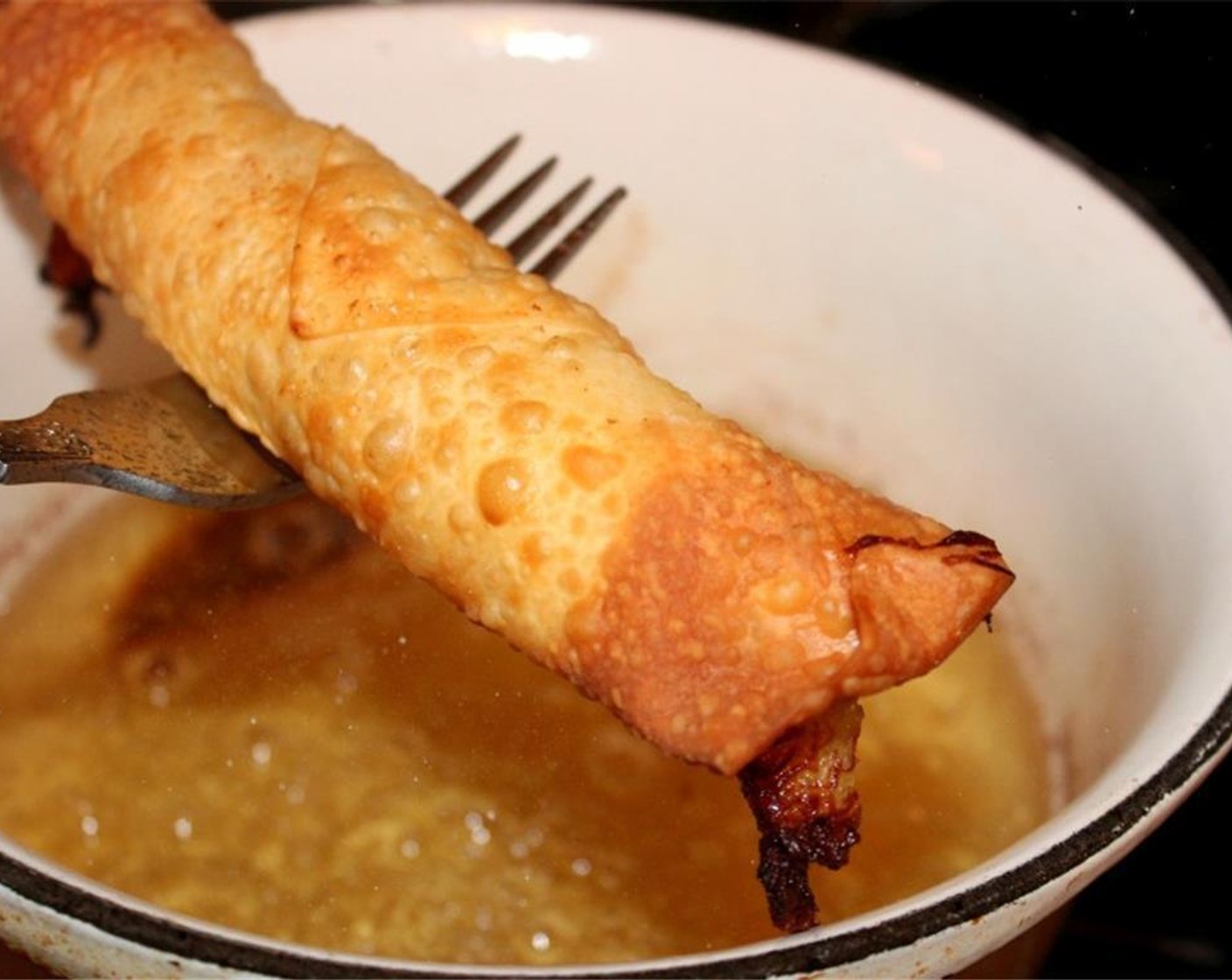 step 4 Heat the Frying Oil (as needed) to 350 degrees F (180 degrees C) and fry the egg rolls until they are evenly golden.