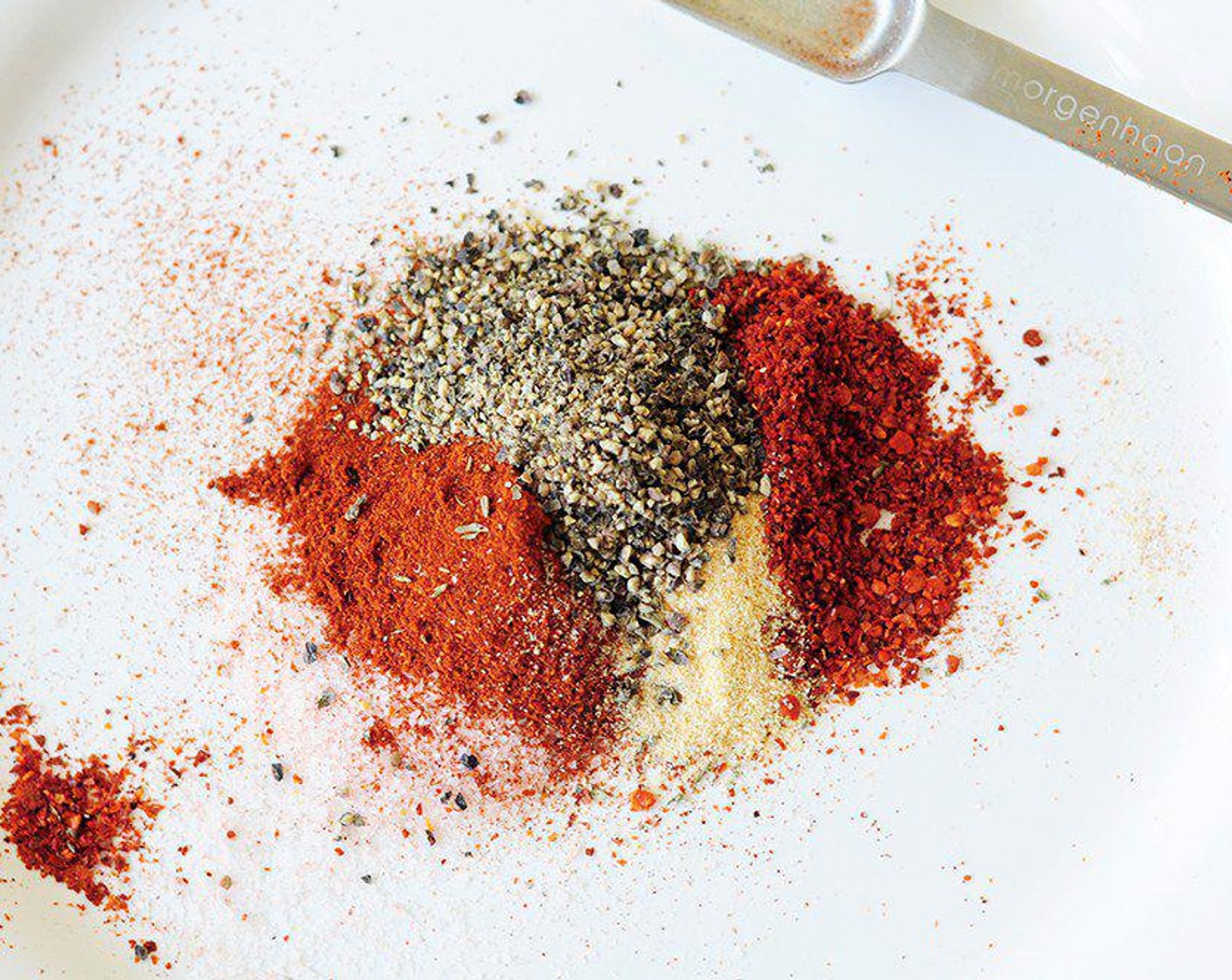 step 2 Mix Kosher Salt (1/2 Tbsp), Paprika (1/2 Tbsp), Cayenne Pepper (1 tsp), Ground Black Pepper (1/2 Tbsp), Dried Thyme (1 tsp), and McCormick® Garlic Powder (1/2 tsp) on a big plate.