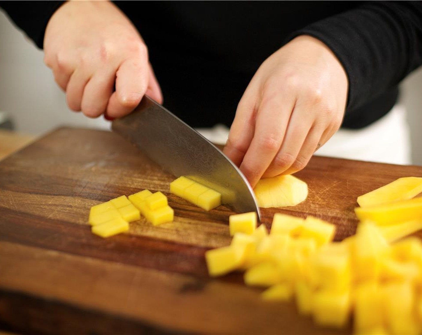 step 1 Peel Mango (1). Carefully cut off the flesh around the pit on all four sides. Discard pit and dice mango into half-inch pieces. Set aside.