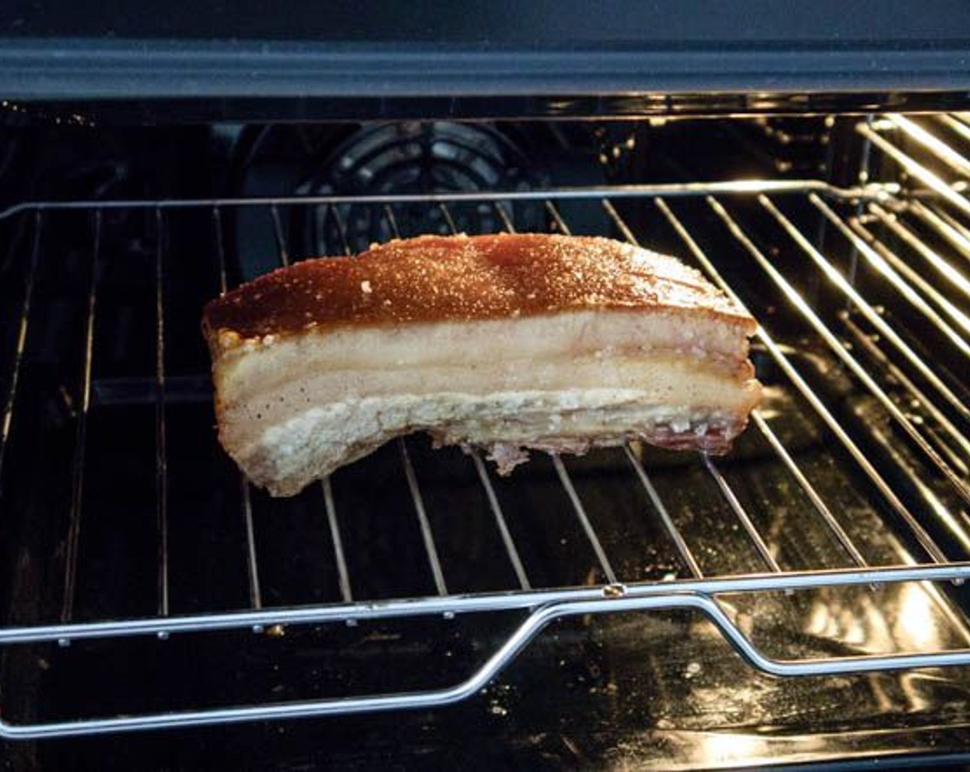 step 10 Remove the sea salt and place the pork belly on the middle rack. Remember to use a tray to catch the dropping oils. Use upper fire only at the temperature of 220 degrees C (425 degrees F), and roast until the rind is golden brown and well crackled.
