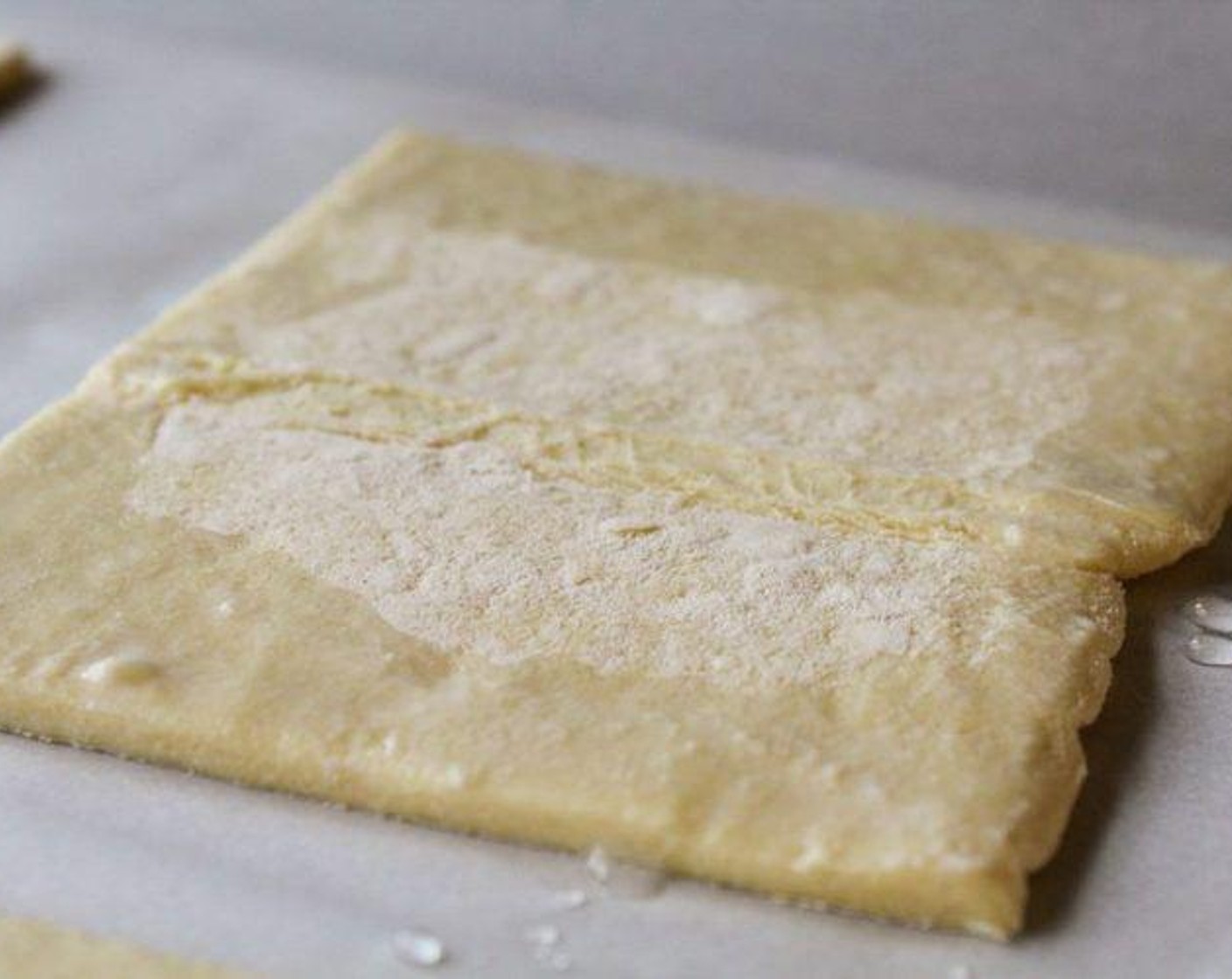 step 3 Place thawed pastry on lined baking sheet. Cut into 8 squares, 4 squares per sheet. On each pastry square, using your finger, wet the edges with Water (1/4 cup). Fold in each side about ½ an inch.